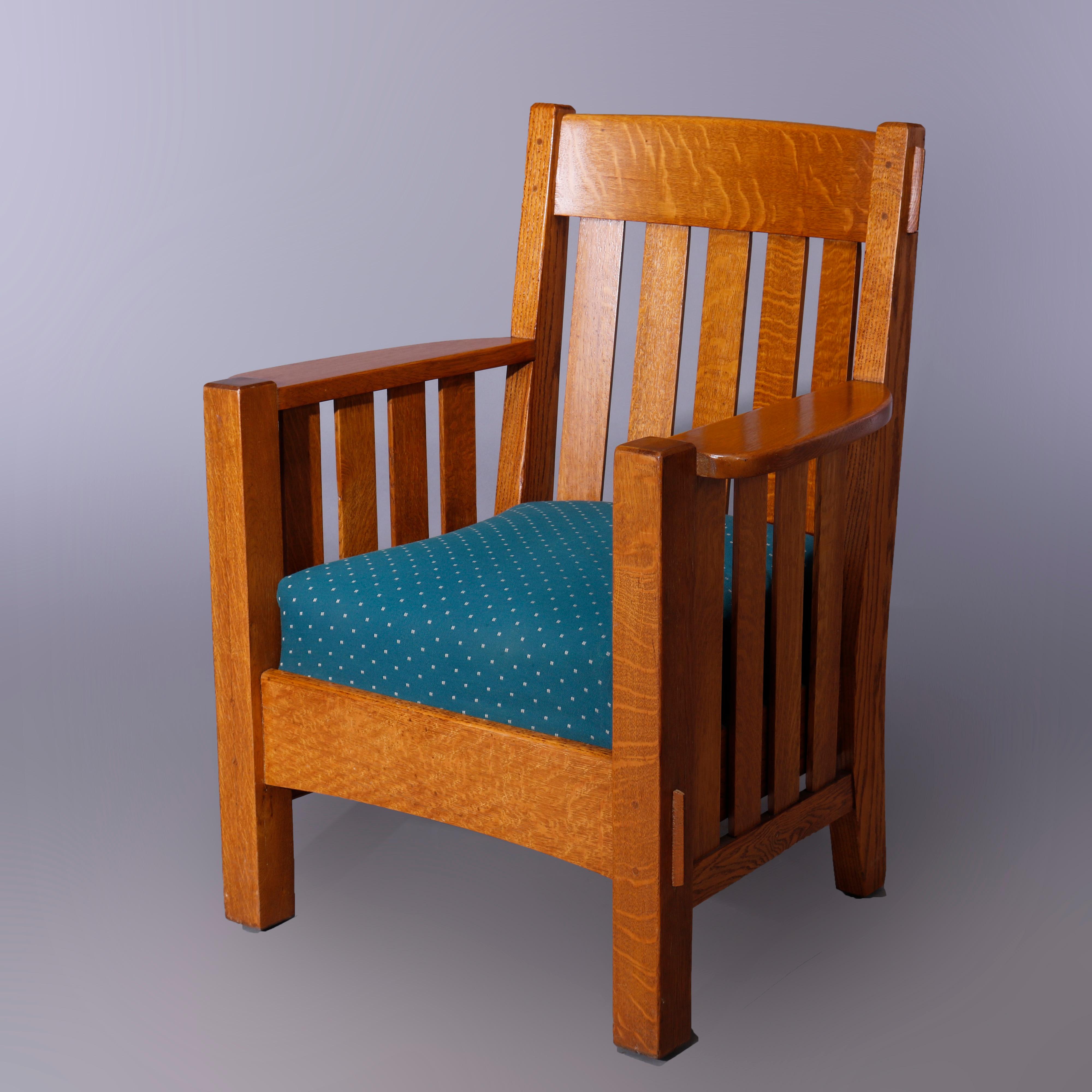 An antique Arts and Crafts harden mission oak arm chair offers slat back and sides with cushion seat, c1910

Measures - 38.25'' H x 30.5'' W x 26.5'' D; seat height 18.5