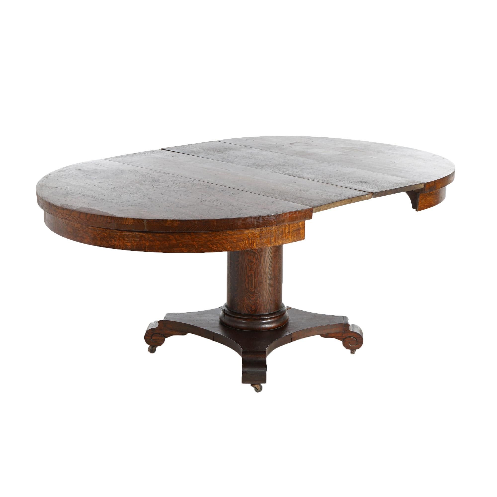 ***Ask About Lower-Rate In-House Shipping Option - Reliable Service, Competitive Feess & Fully Insured***
An antique Arts & Crafts Wolverine extension dining table offers oak construction in round form over central column and raised on base having