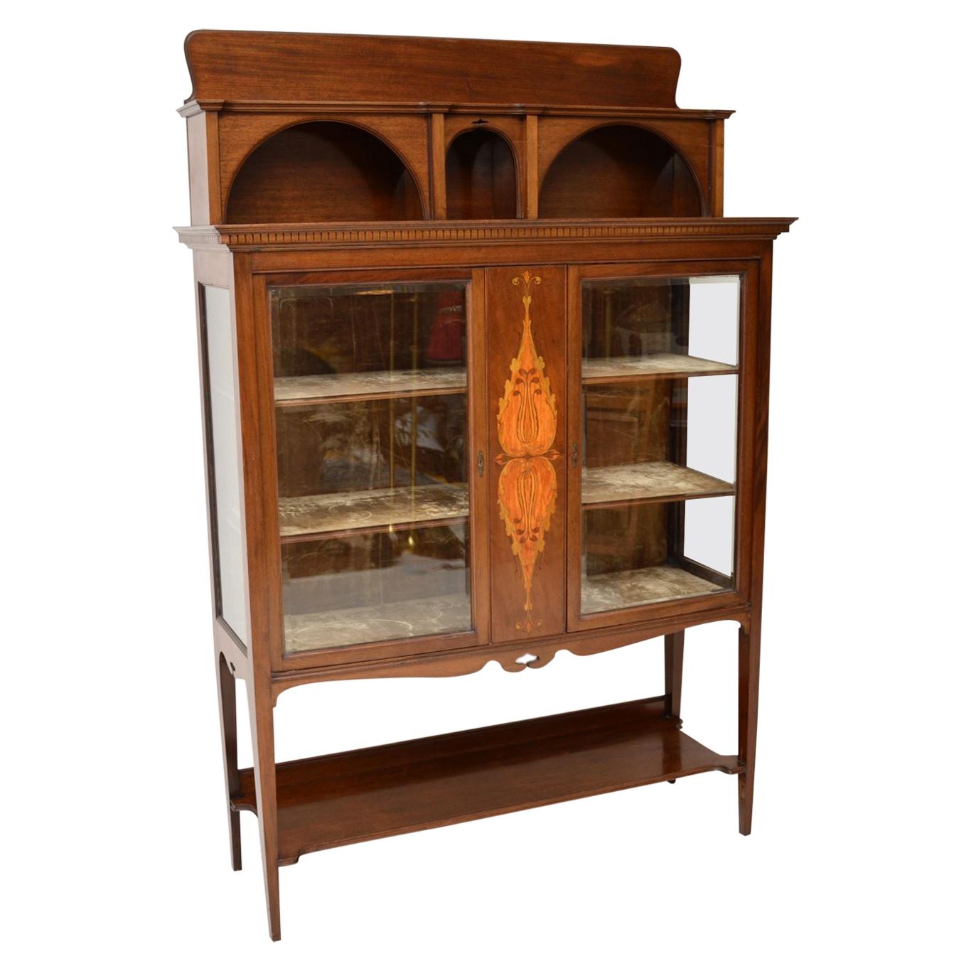 This antique Arts & Crafts mahogany display cabinet was bought from Liberty in 1991 for £2750 & we still have the original receipt which we have show in one of the images. It’s totally original & still in very good condition, right down to the