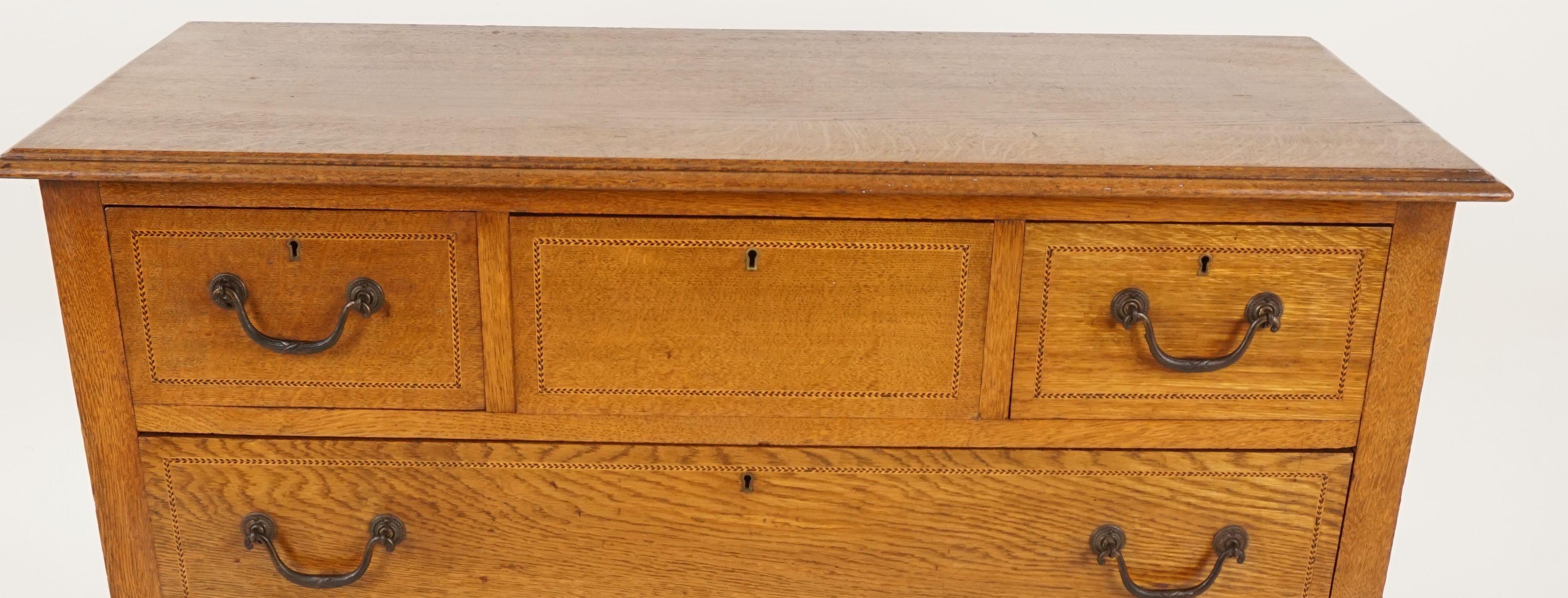 Antique Arts & Crafts inlaid oak dresser, chest of drawers, Scotland, 1910

Scotland, 1910
Solid oak and Walnut veneer
Original finish
Rectangular moulded top
Central inlaid drawer
Flanked by a pair of short dovetailed drawers
Three graduated inlaid
