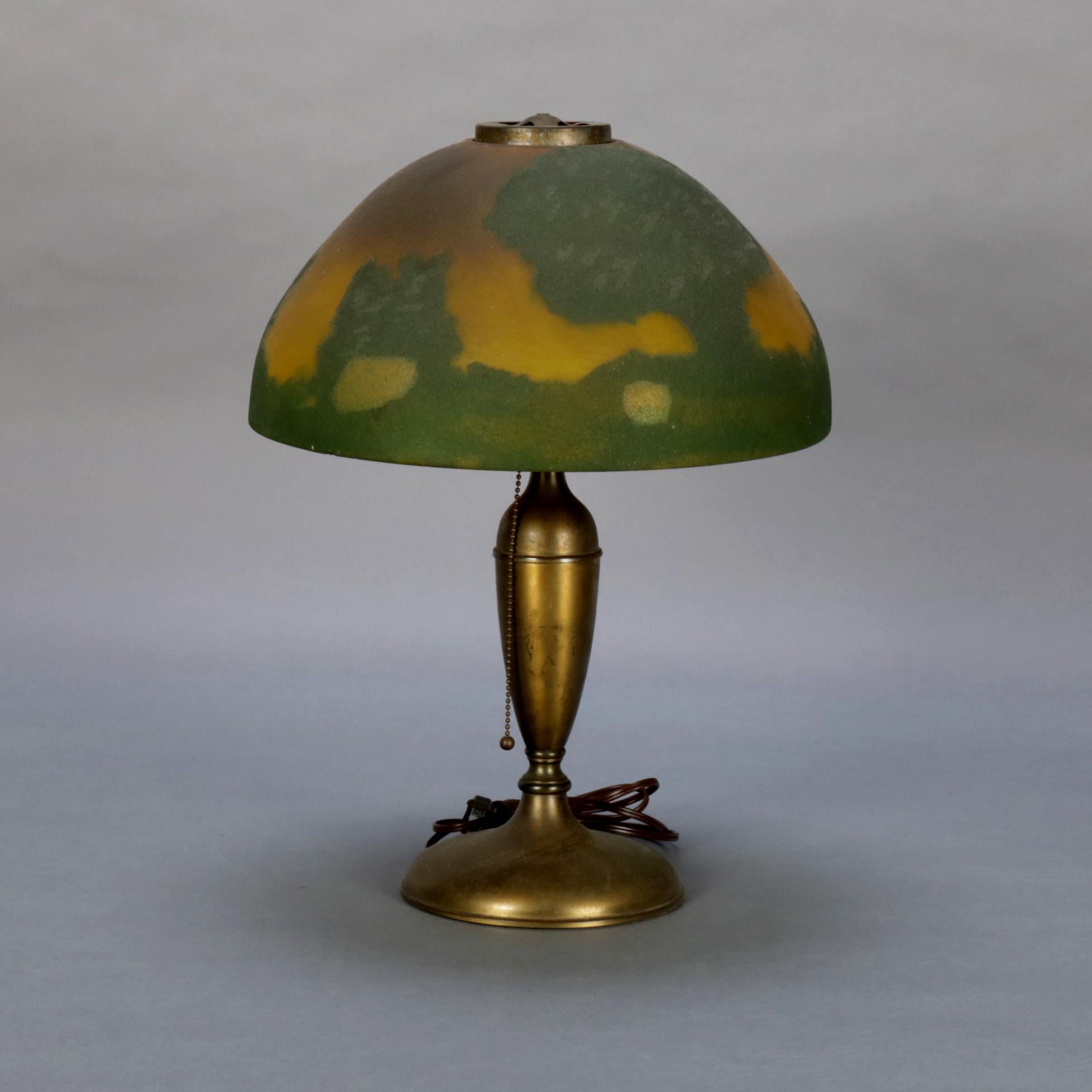 An antique arts and crafts Jefferson table lamp features single socket and urn form base with scenic landscape reverse painted glass dome shade, working and with professional rewiring, circa 1910.

Measures: 18.5