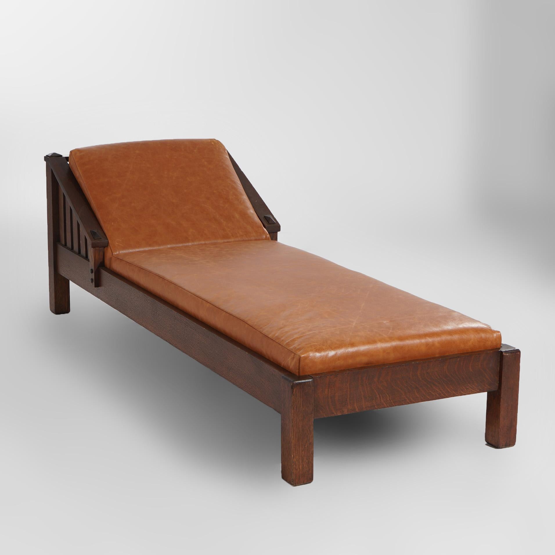 ***Ask About Discounted In-House Shipping***
An antique Arts and Crafts Mission daybed by JM Young Mission offers oak frame with slat sides, upholstered cushion and raised on straight square legs; maker label remnants as photographed;