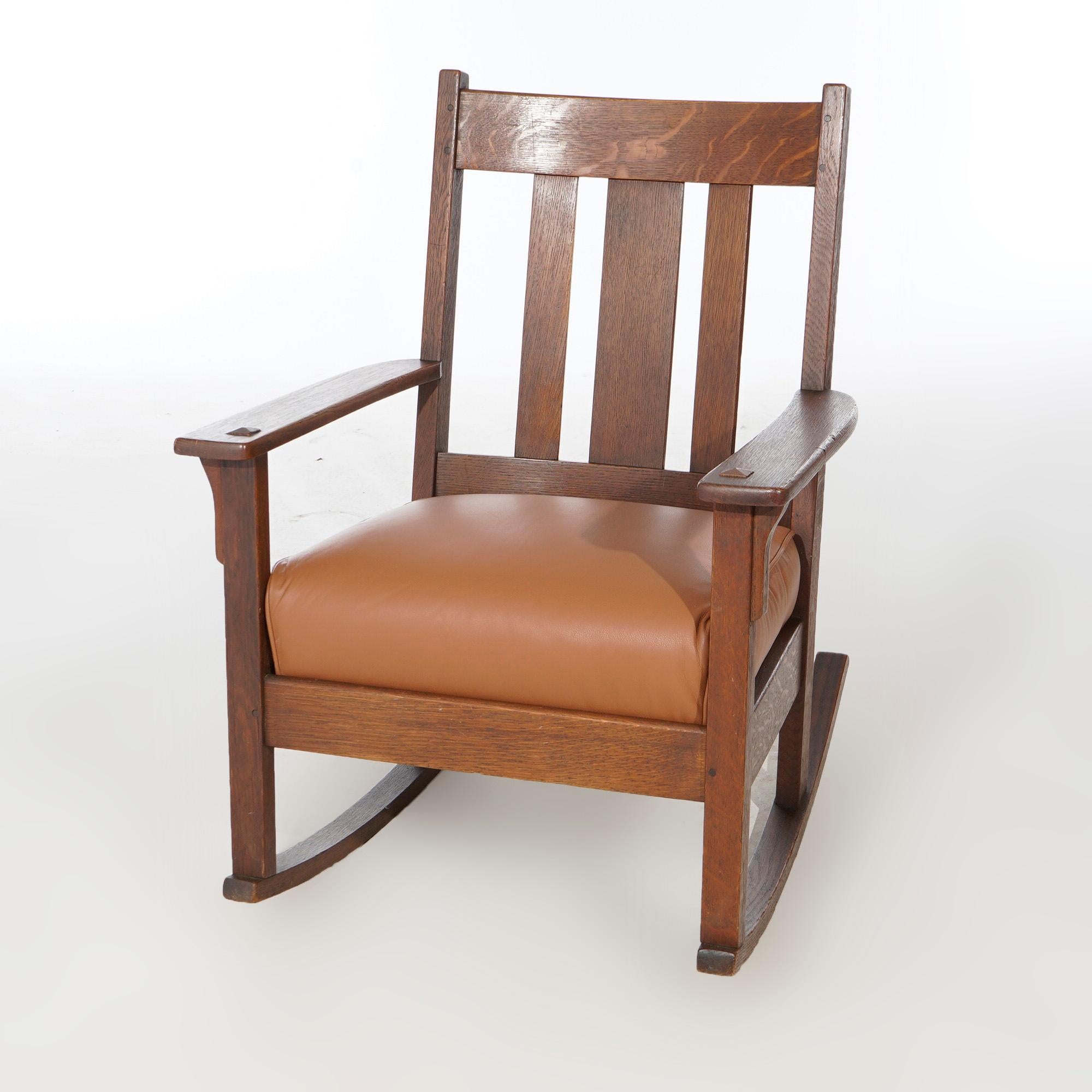 An antique Arts and Crafts rocking chair by JM Young offers quarter sawn oak construction with slat back over upholstered seat, c1910.

Measures- 35''H x 26.75''W x 30''D.

*Ask about DISCOUNTED DELIVERY rates within 1,500 miles of NY*