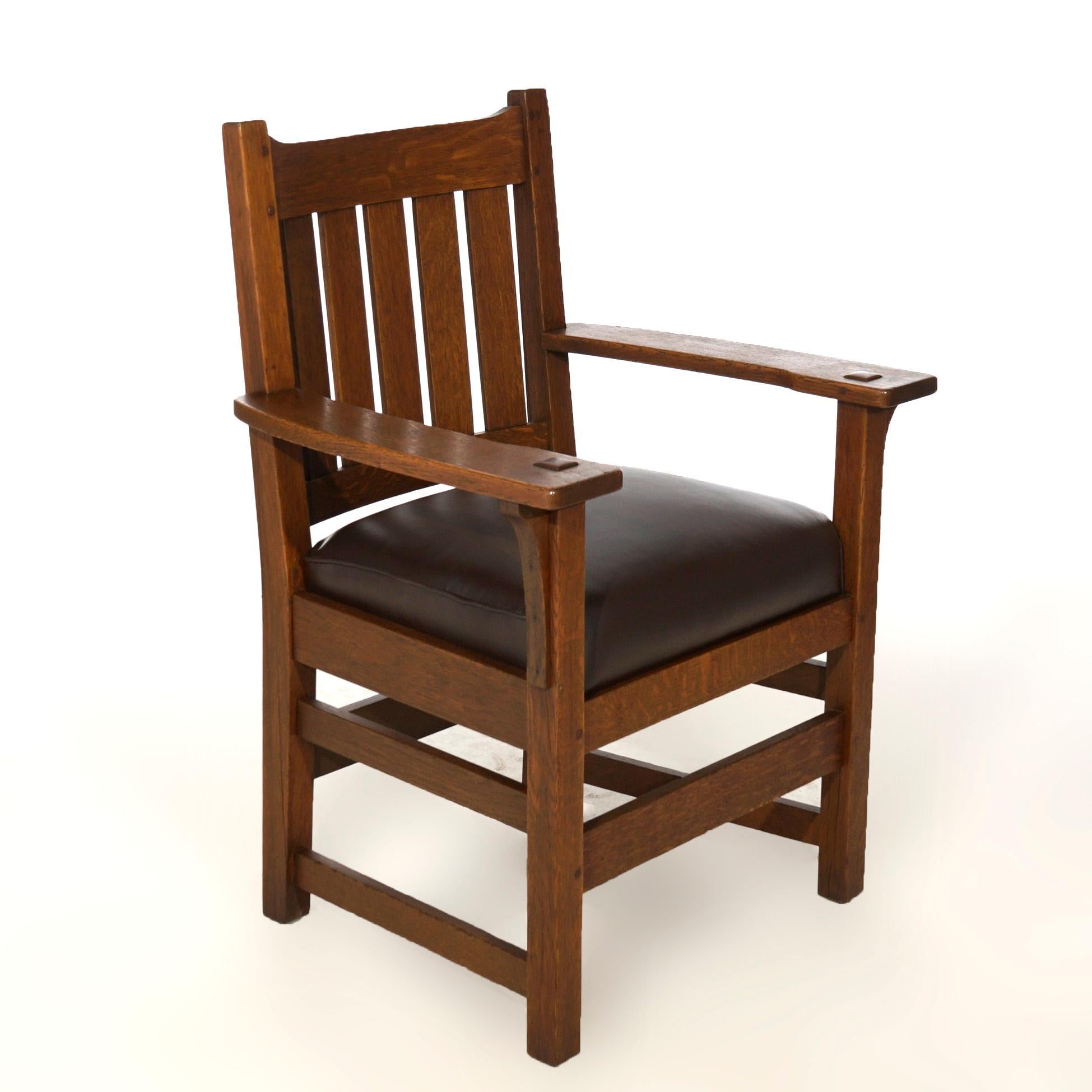 An antique Arts and Crafts arm chair by L & JG Stickley arm chair offers quarter sawn oak construction with slat back, maker label as photographed, c1910.

Measures- 36.5''H x 27''W x 22''D.

*Ask about DISCOUNTED DELIVERY rates within 1,500 miles