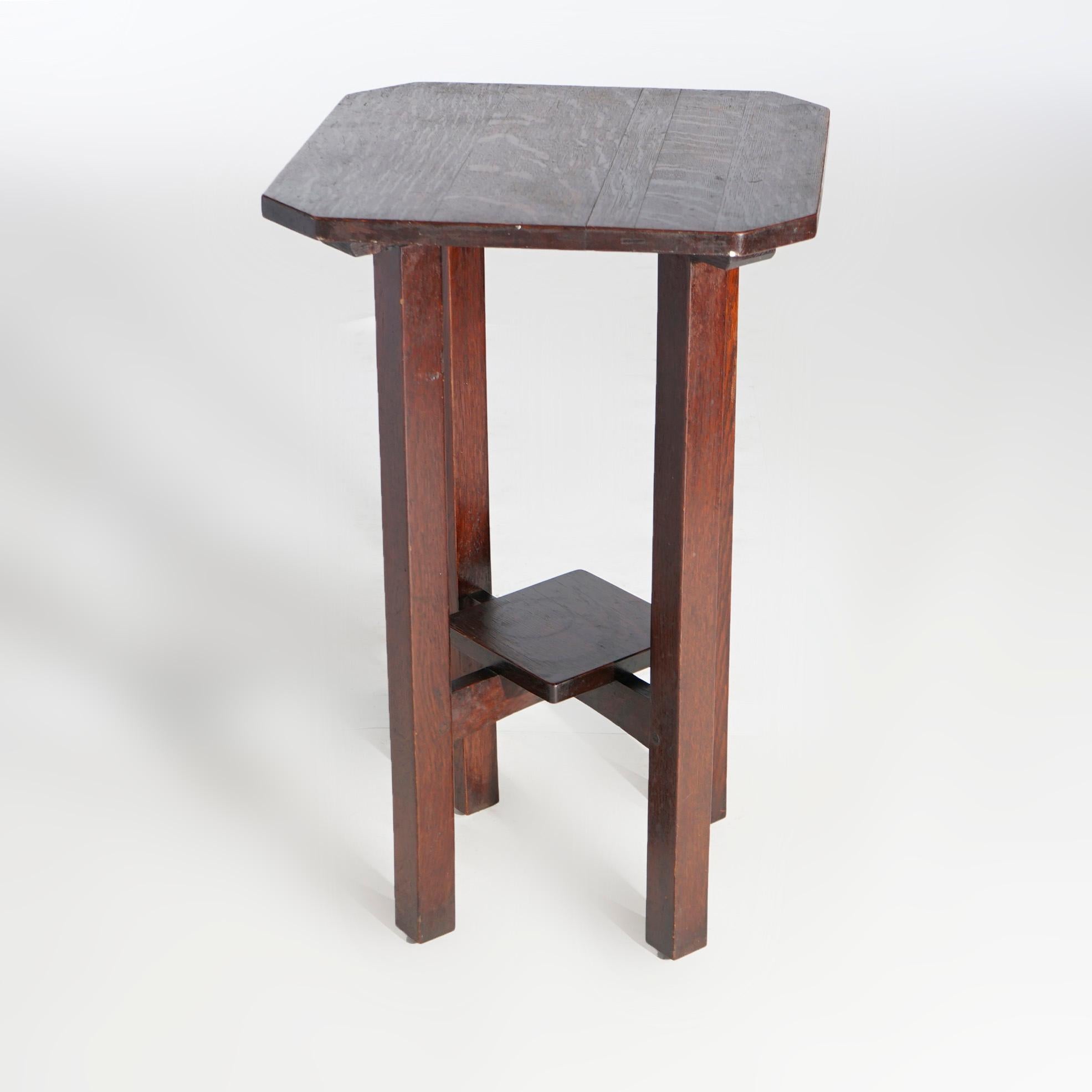 An Arts and Crafts drink stand by L & JG Stickley offers quarter sawn oak construction with clip corner top over square and straight legs having x-stretcher with lower display, c1910

Measures- 29'' H x 18'' W x 18'' D.