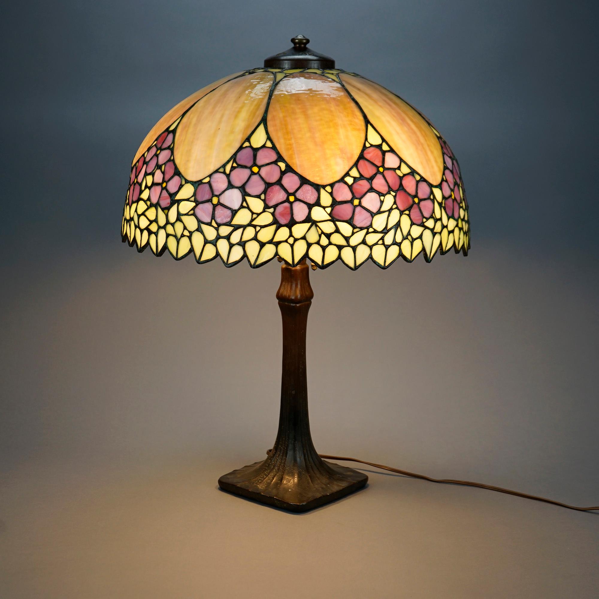 An antique Arts & Crafts table lamp with dome form leaded glass Unique shade having flowers and stylized leaves over Handel double socket tree trunk base, c1910

Measures- 24.5''H x 18.25''W x 18.25''D.

Catalogue Note: Ask about DISCOUNTED DELIVERY
