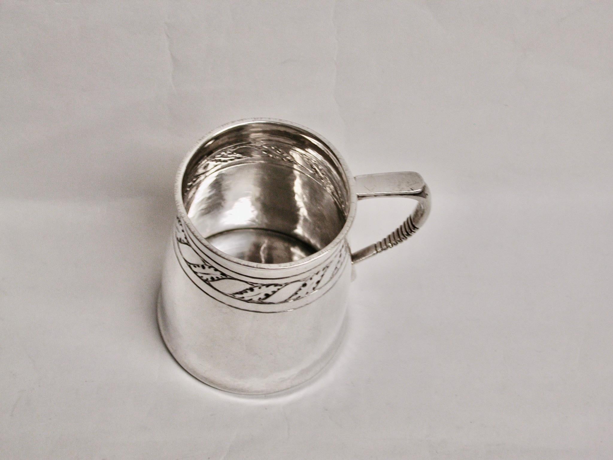 Antique Arts & Crafts Liberty & Co Silver Child's Tankard Dated 1923 Birmingham
Beautifully crafted with hand hammering with a leaf type garland around the top
 of the tankard.