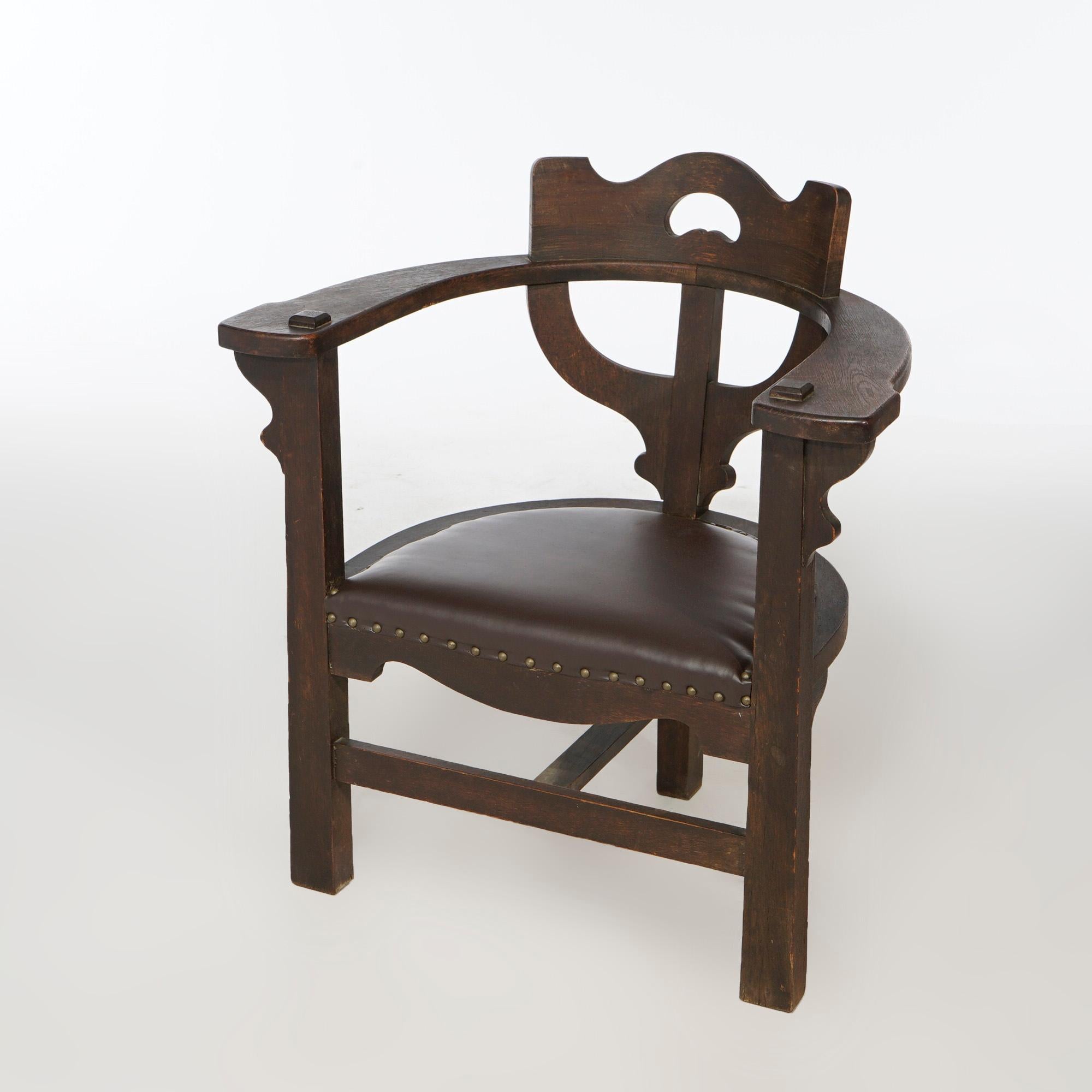 An antique Arts and Crafts Mission arm chair in the manner of Limbert offers quarter sawn oak construction with curved back having stylized candelabra slat and flat arms over upholstered seat and raised on square and straight legs, c1910

Measures-