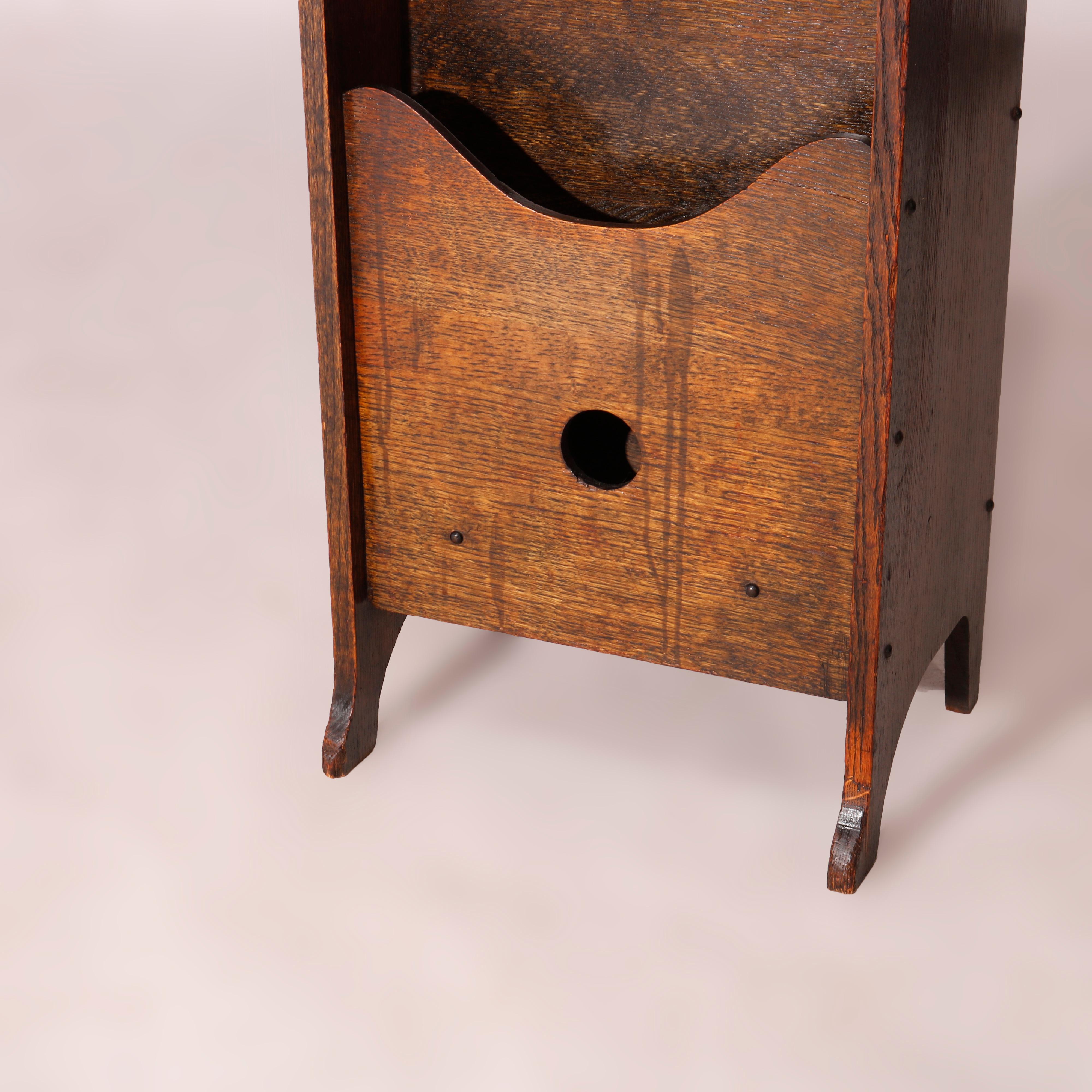 An antique Arts & Crafts magazine stand in the manner of Limbert offers oak construction with upper having cut-out squares over graduated media portfolio, c1910

Measures - 37