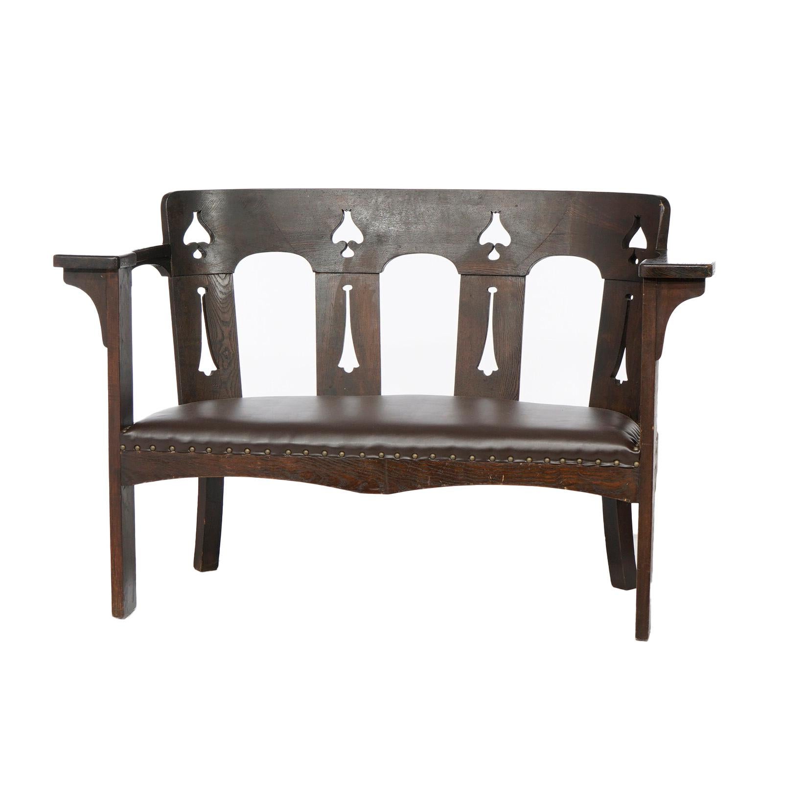 An antique Arts and Crafts settee in the manner of Limbert offers oak construction with curved slat back having cut-out stylized floral elements over upholstered seat and flat arms, c1910

Measures- 34.75''H x 54''W x 24''D

*Ask about DISCOUNTED