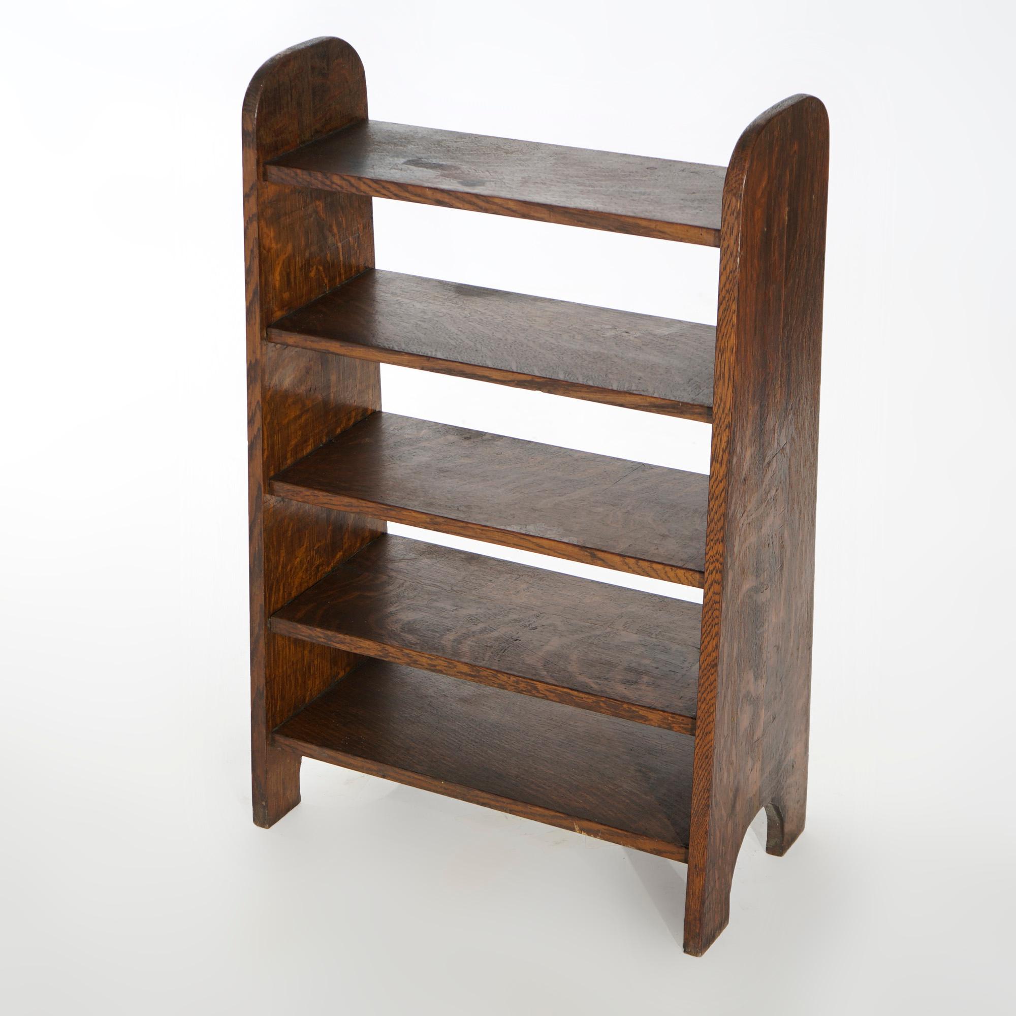 An antique Arts and Crafts book rack in the manner of Limbert offers oak construction in tapered form with five shelves, c1910

Measures- 34.25''H x 21.75''W x 11.25''D.