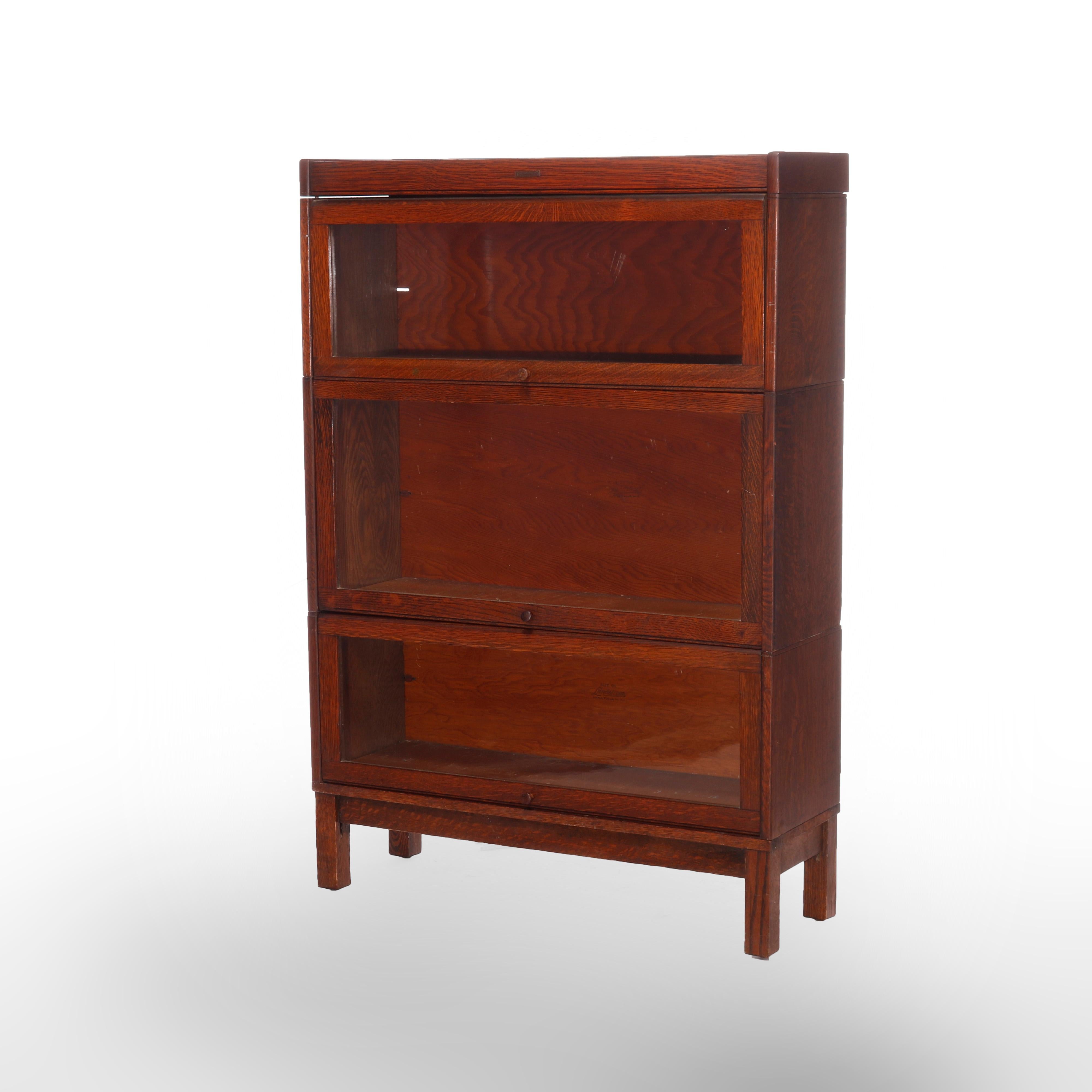 An antique Arts & Crafts Barrister bookcase by Lundstrom offers quarter sawn oak construction with three stacks, each having pull out glass doors and raised on straight and square legs, maker label as photographed, c1910

Measures - 49''H X 33.75''W