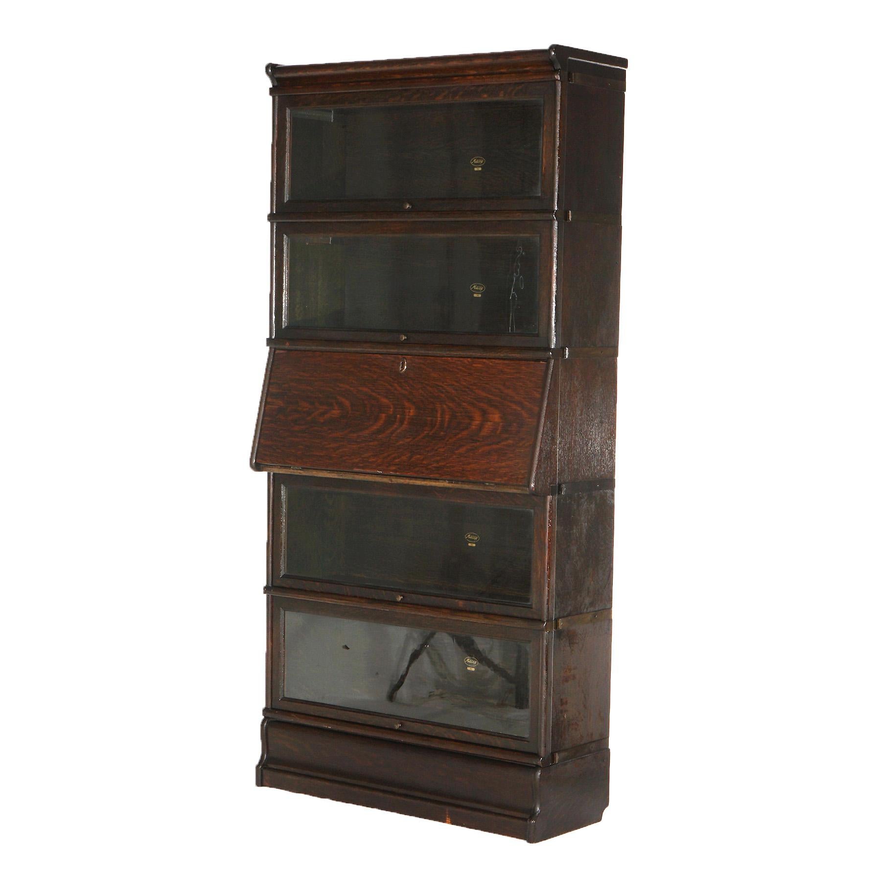 ***Ask About Reduced In-House Shipping Rates - Reliable Service & Fully Insured***
An antique Arts and Crafts barrister bookcase by Macey offers quarter sawn oak construction with fur stacks having pullout glass doors and one with drop-down desk,