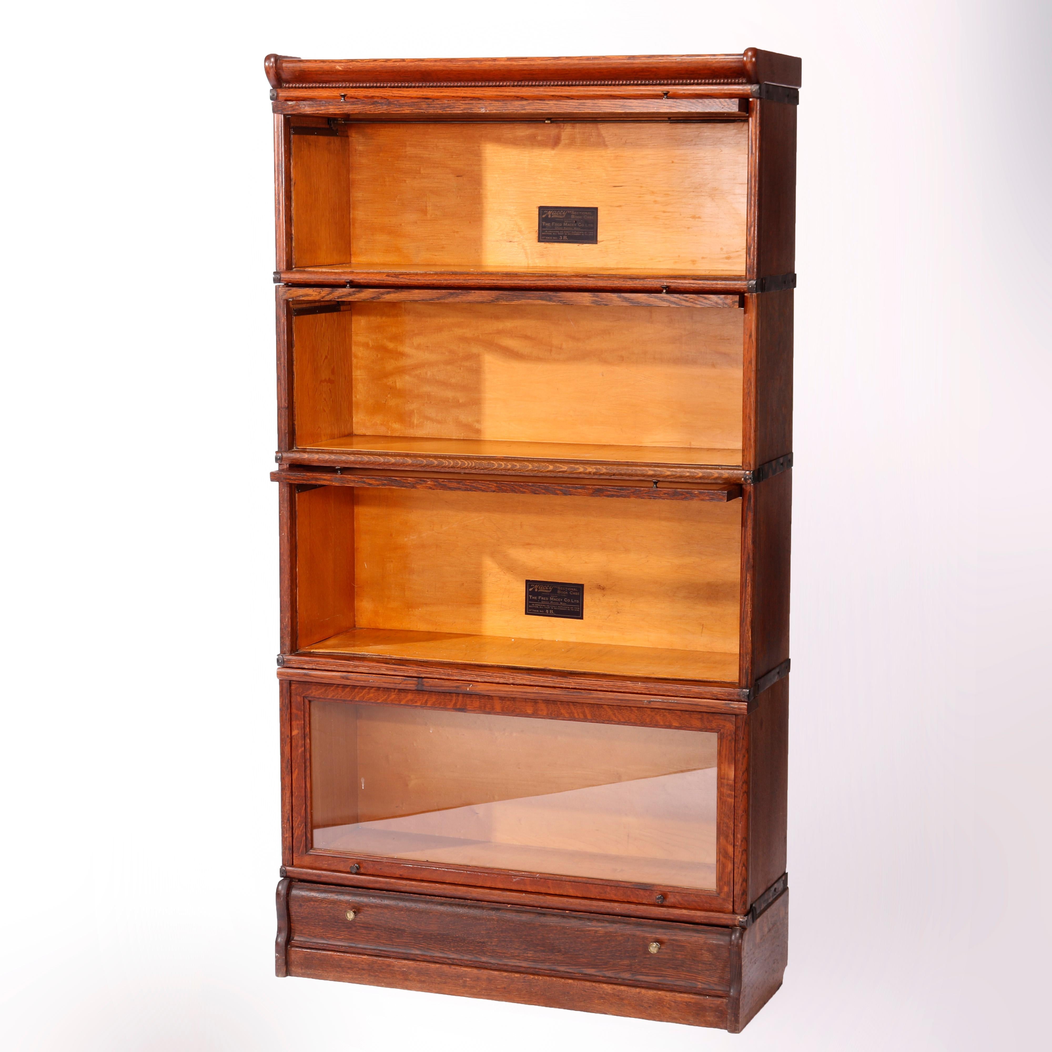 An antique Arts & Crafts Mission Barrister bookcase by Macey offers oak construction with four stacks, each having pull out glass doors and seated on ogee base with drawer, maker label as photographed, c1910

Measures - 64.5'' H x 34.25'' W x 12.5''