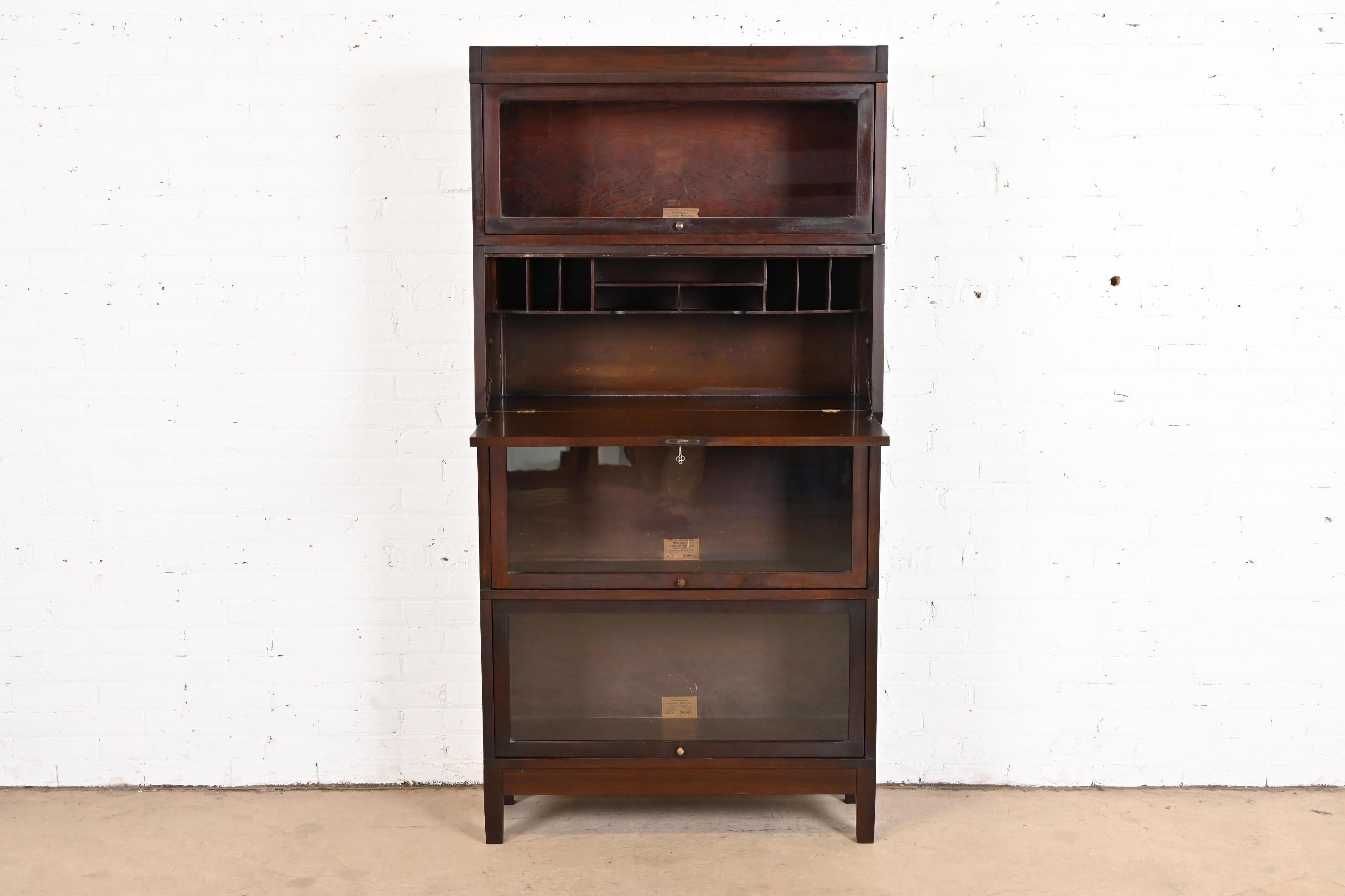 A gorgeous antique Arts & Crafts stacking barrister bookcase with fall front secretary desk

By Globe Wernicke

USA, circa 1900

Mahogany, with glass front doors and brass hardware. Desk locks, and key is included.

Measures: 34.25