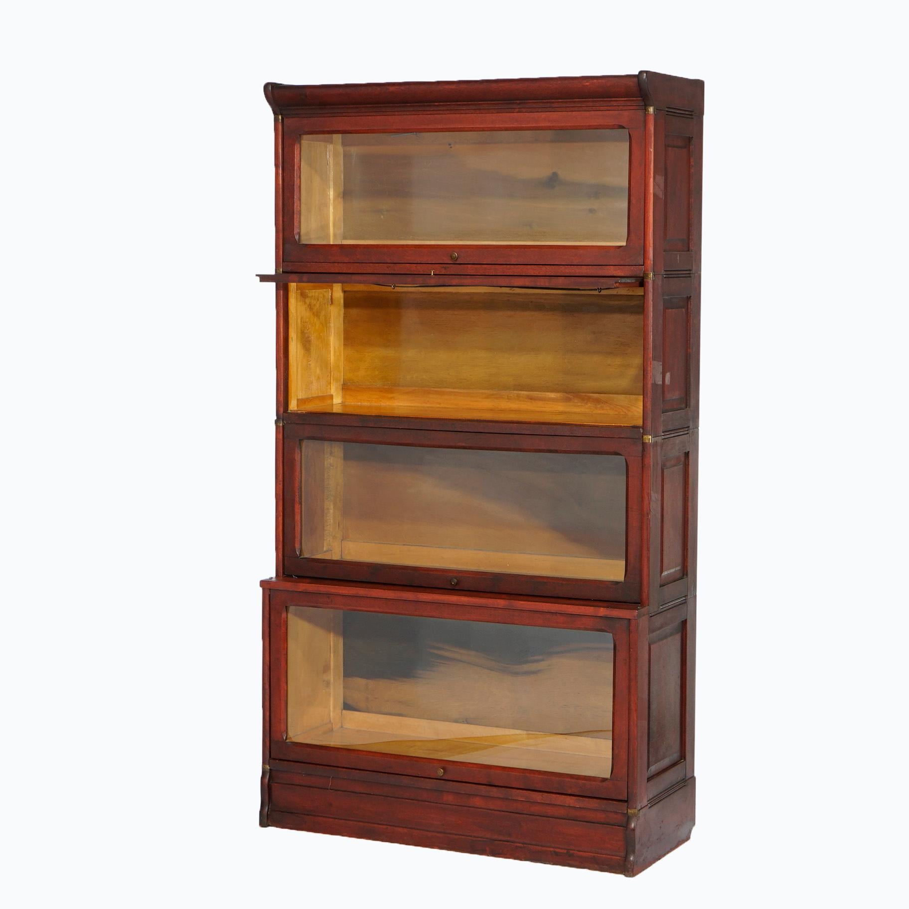 An antique Arts and Crafts barrister bookcase offers mahogany raised panel construction with four stacks having pull out glass doors, c1910

Measures- 66.25'' H x 36'' W x 14.5'' D.