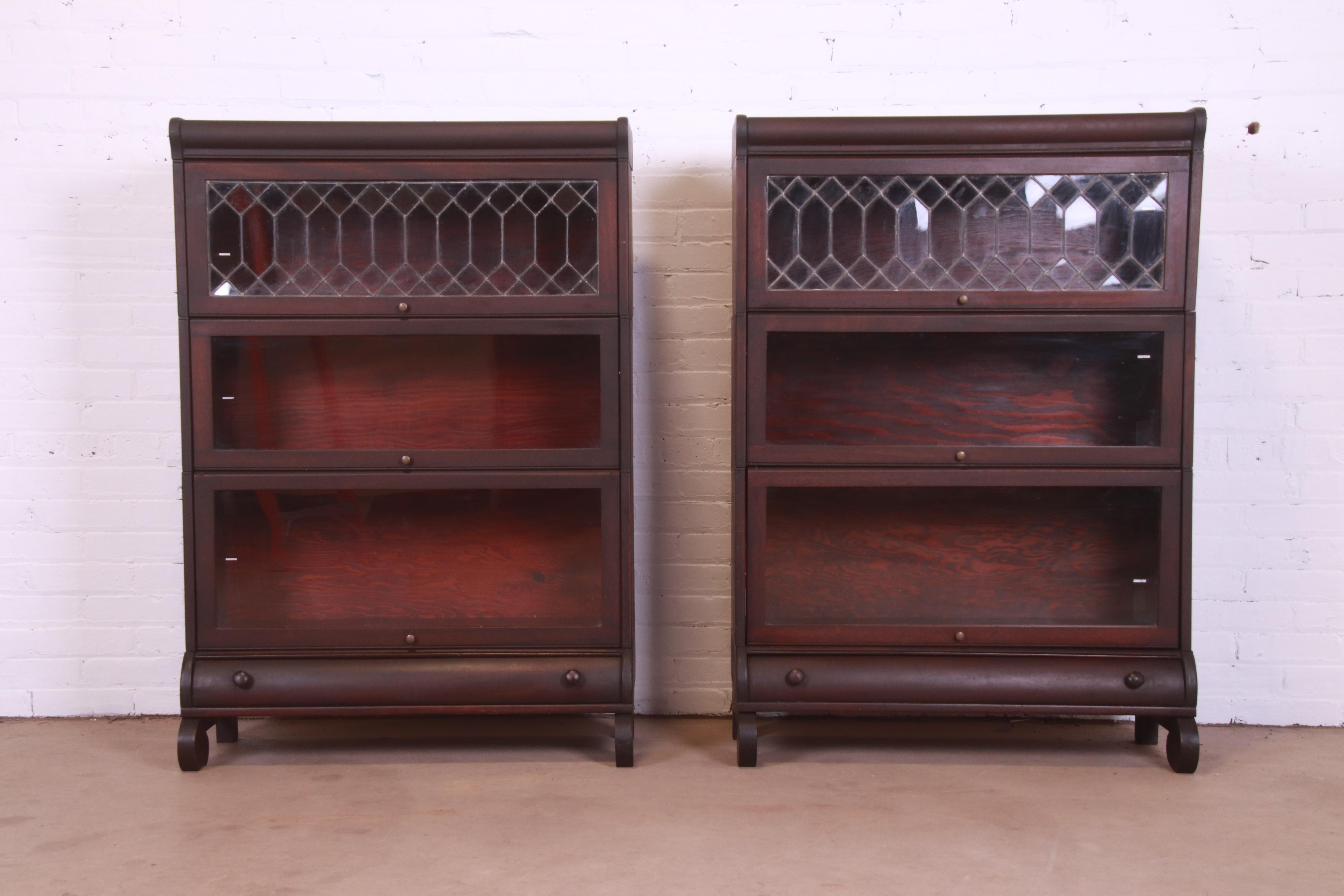 A gorgeous pair of antique Arts & Crafts three-stack barrister bookcases with leaded glass

By Lundstrom Furniture

USA, Circa 1900

Mahogany, with glass front doors and original brass hardware.

Measures: 33.75