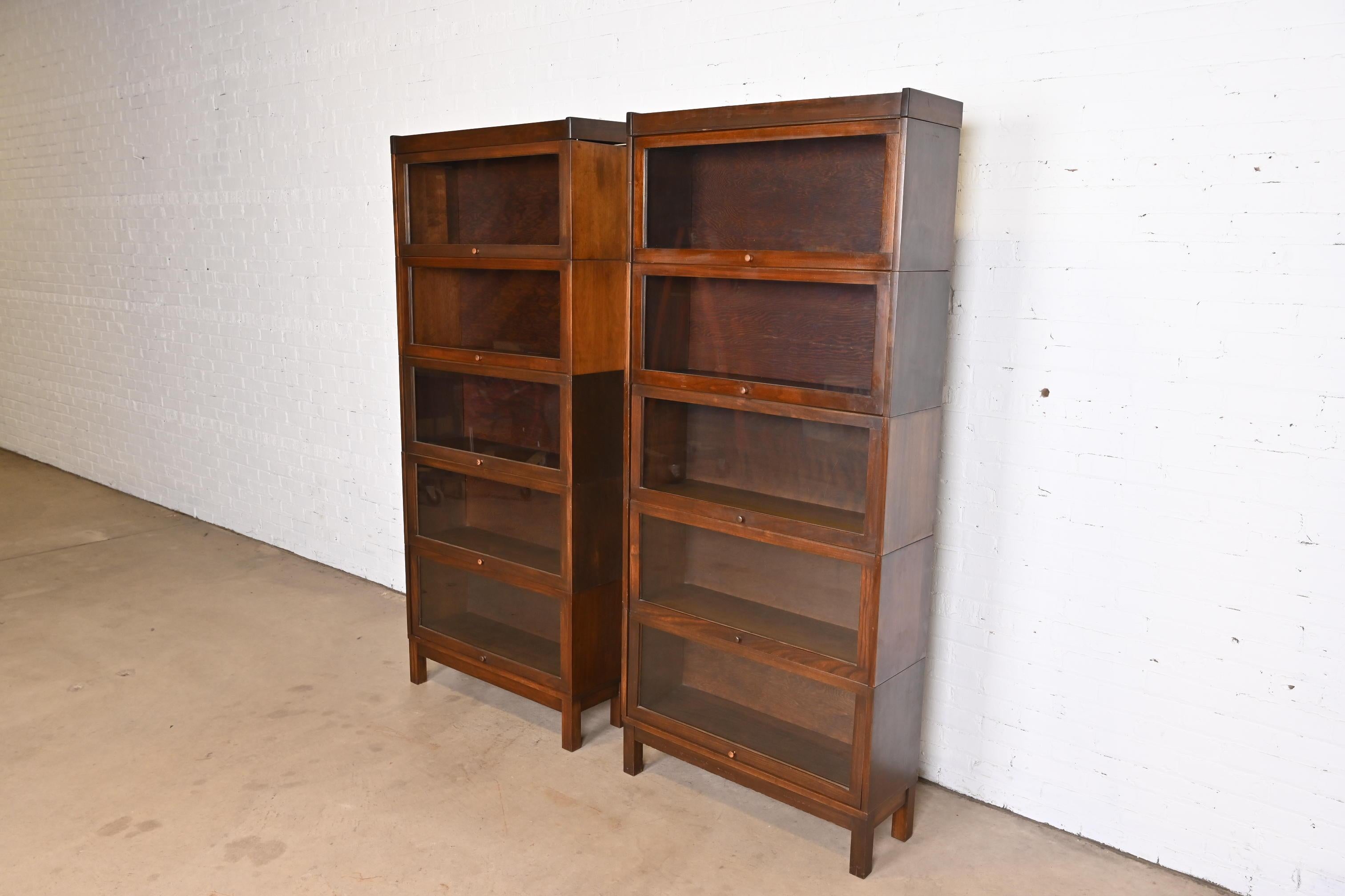 A gorgeous pair of antique Arts & Crafts five-stack barrister bookcases

In the manner of Globe Wernicke

USA, Circa 1920s

Mahogany, with glass front doors.

Each bookcase measures: 33.75
