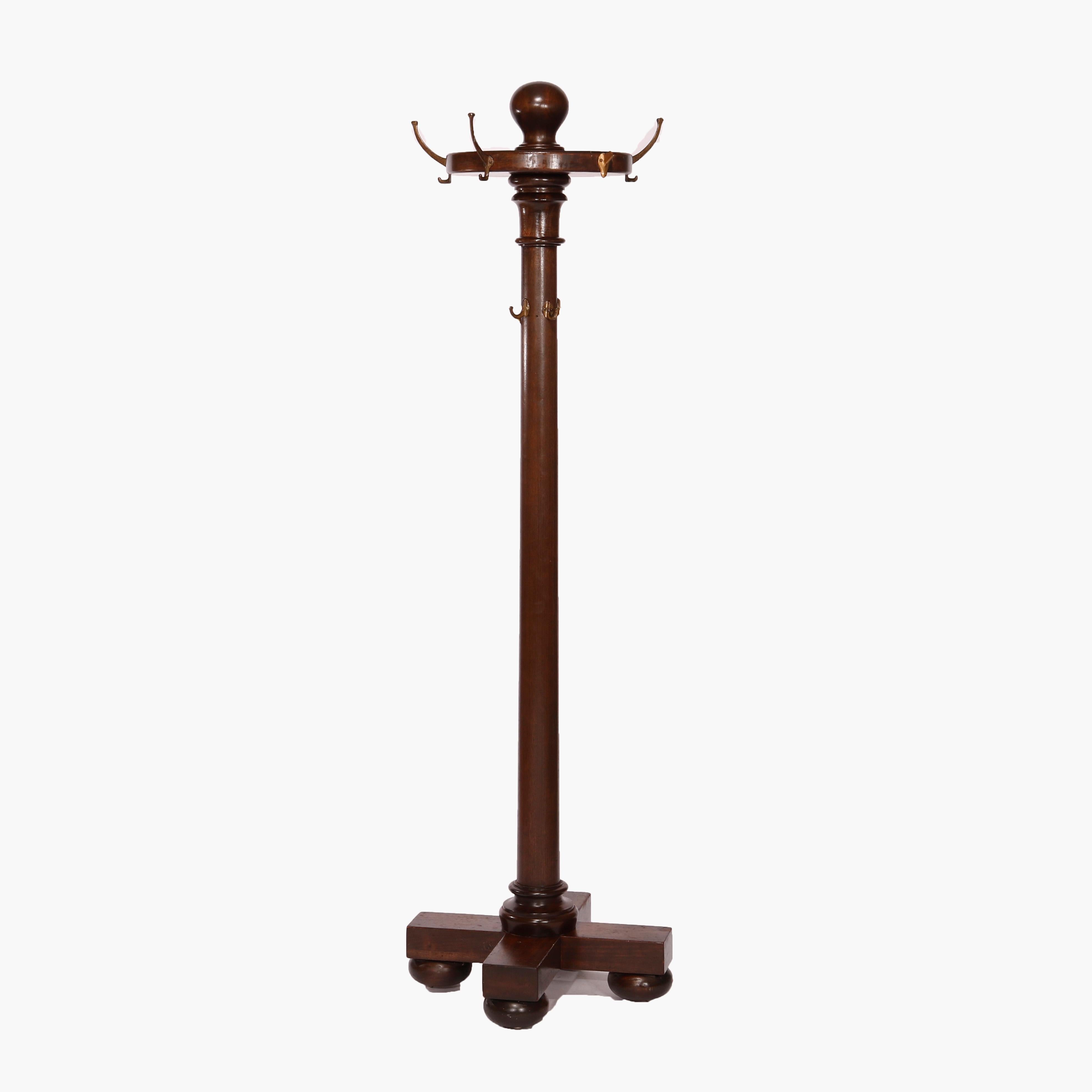 An antique Arts and Crafts hall hat rack offers mahogany construction with turned column seated on base with bun feet, c1910

Measures- 72''H x 21.25''W x 21.25''D.

Catalogue Note: Ask about DISCOUNTED DELIVERY RATES available to most regions