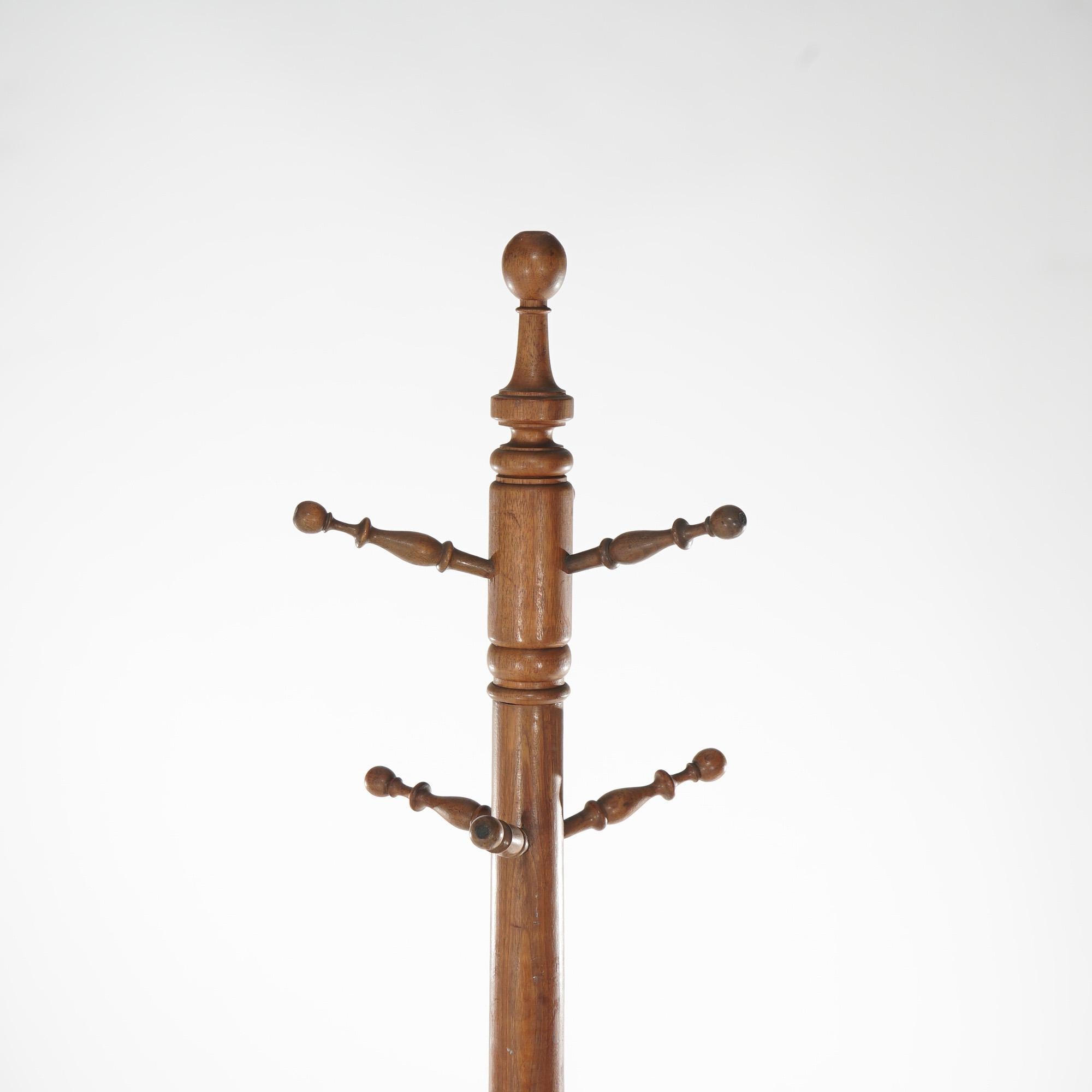 An antique Arts and Crafts hat rack offers mahogany construction with turned column and hat pegs, raised on quadruped base, c1930

Measures - 75.5