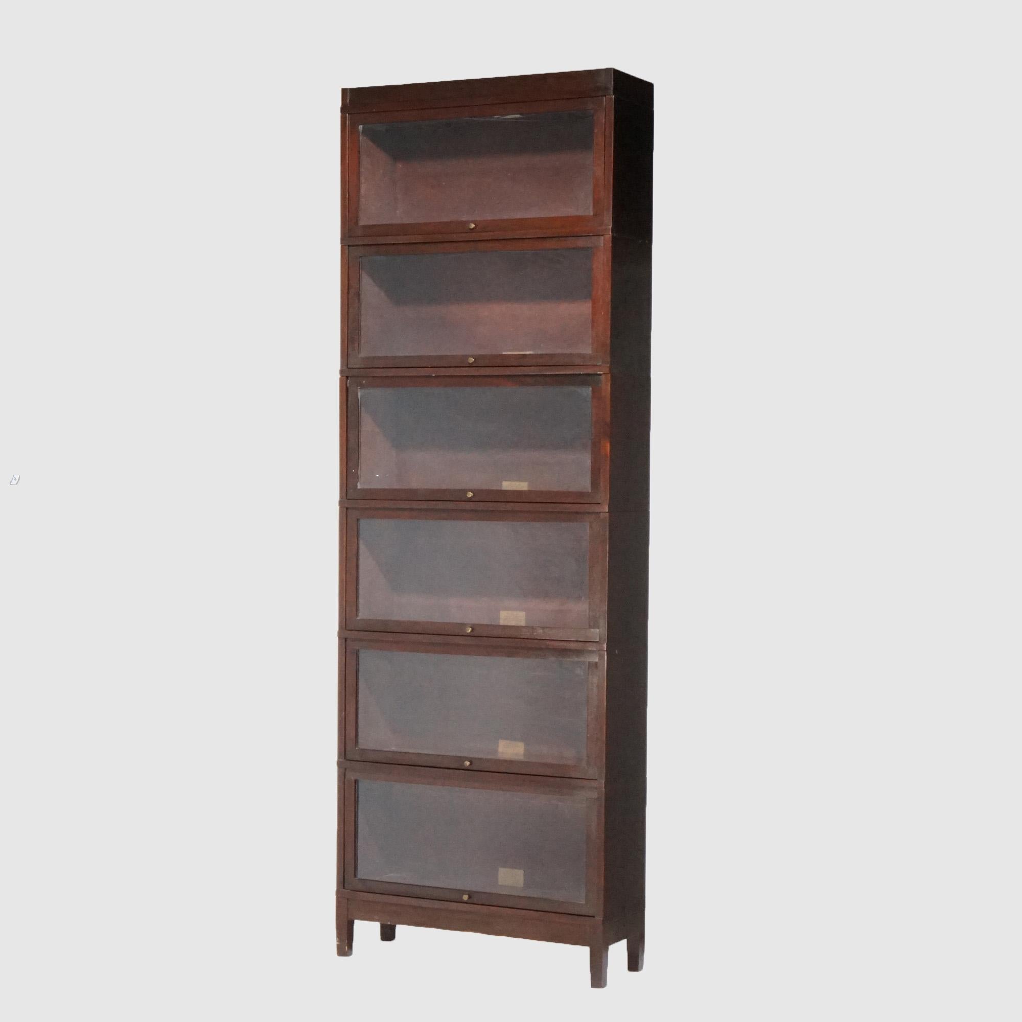 An antique Arts and Crafts barrister bookcase by Globe Wernicke offers mahogany construction with six stacks, each having pull-out glass doors and raised on square and straight legs; makers labels as photographed; c1910

Measures - 100.5