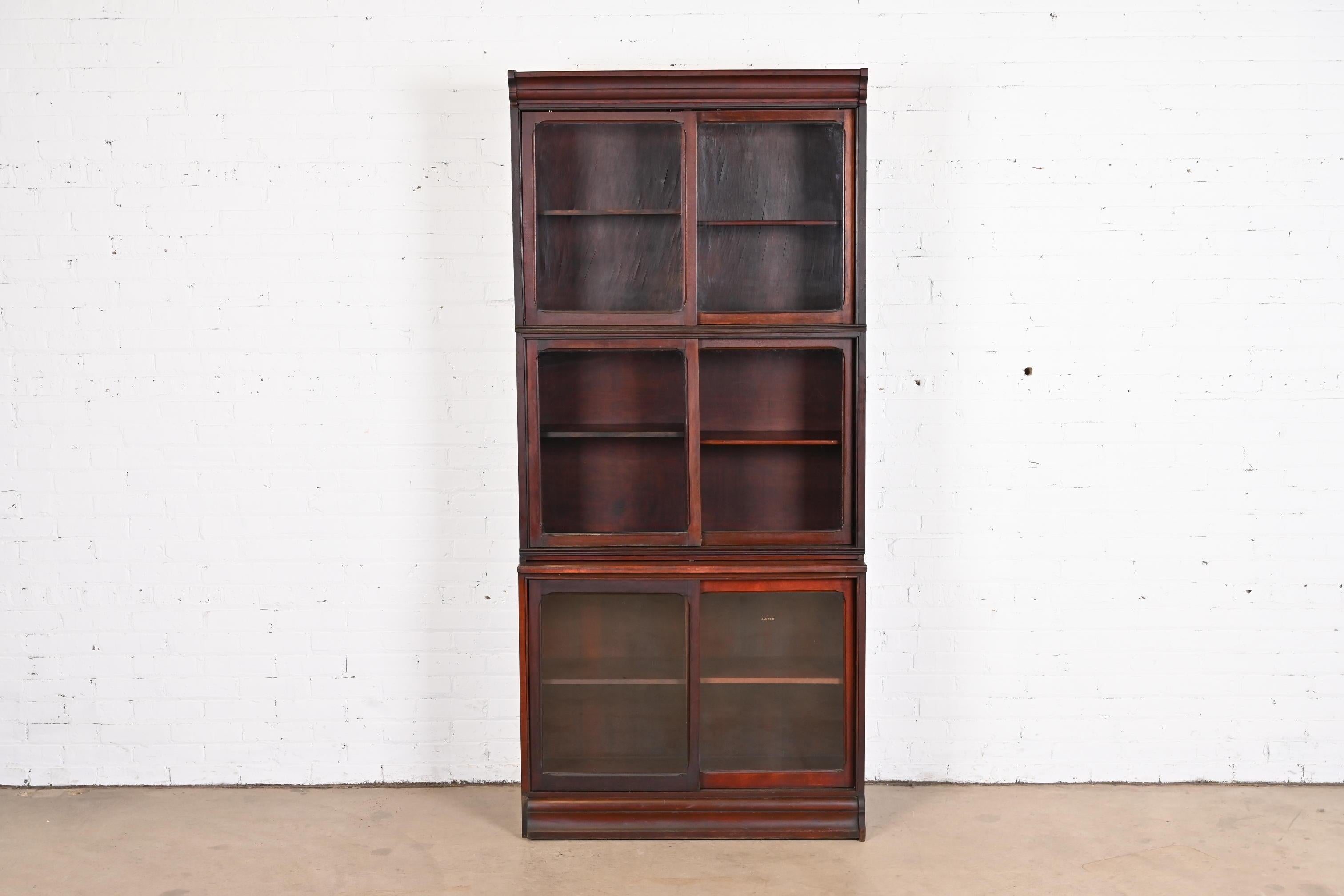 A gorgeous antique Arts & Crafts stacking barrister bookcase with sliding glass doors

In the manner of Globe Wernicke

By Danner

USA, Circa 1920s

Mahogany, with glass front doors.

Measures: 37