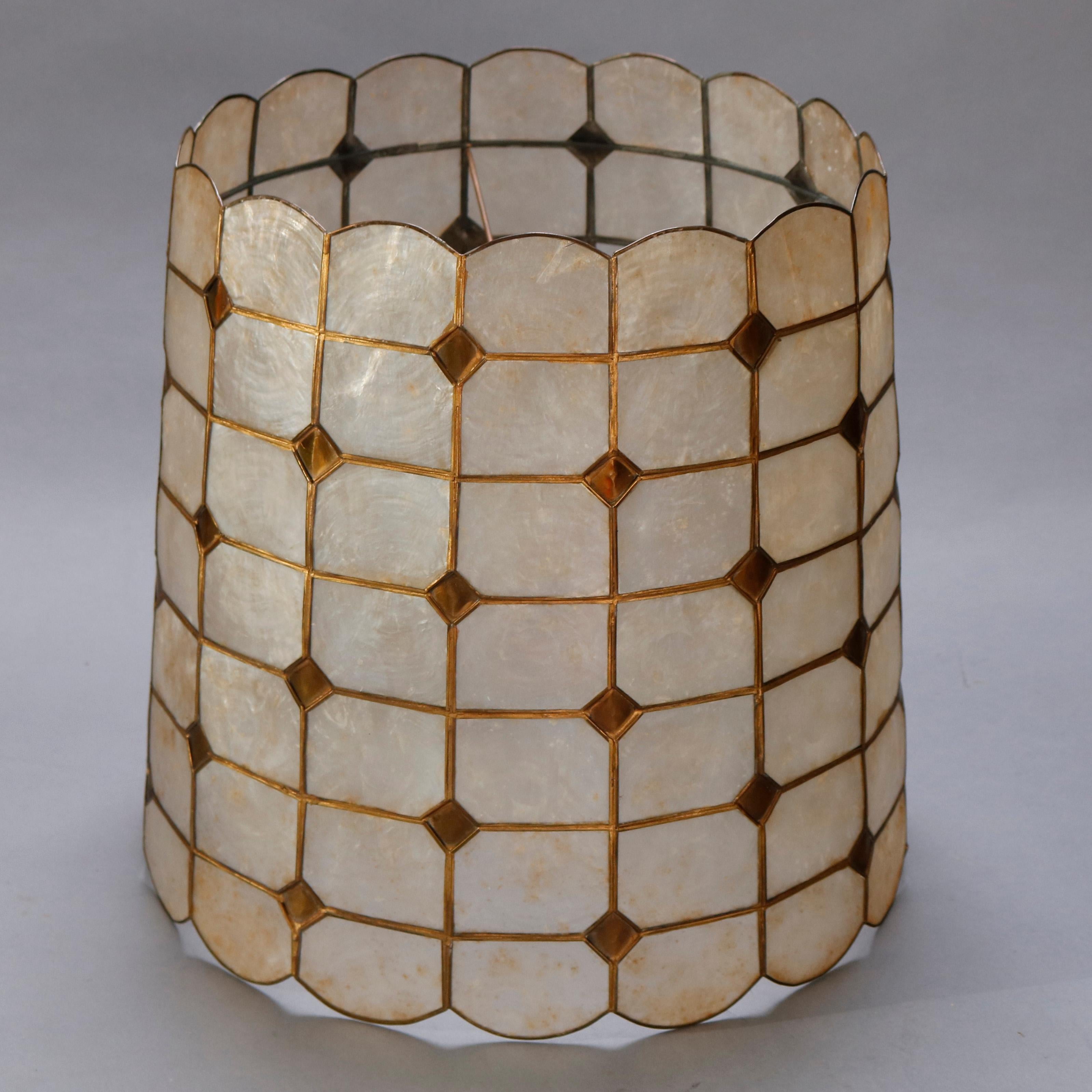 An antique Arts & Crafts table lamp shade offers repeating pattern of geometric mica segments in leaded brass frame, circa 1920

Measures: 13.75
