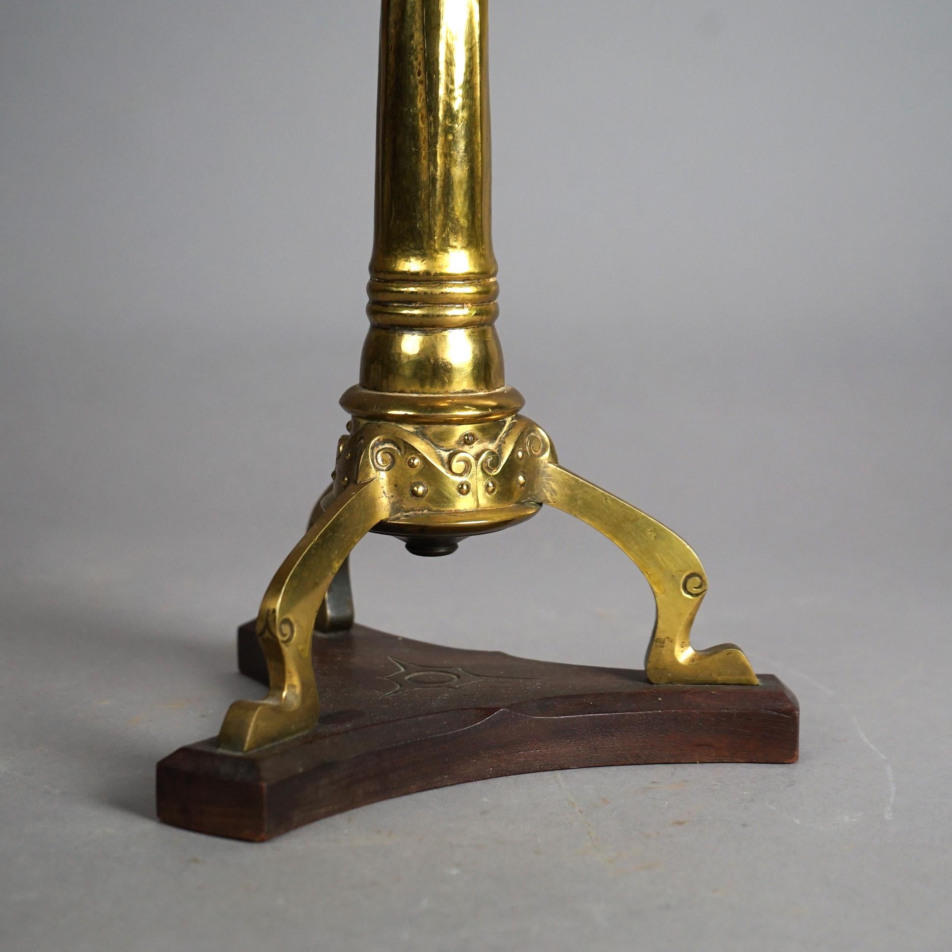 An antique Arts and Crafts Mission kerosene oil lamp offers brass construction with fringed hammered helmet form shade over base raised on stylized lion form legs, c1910

Measures- 24.25''H x 9''W x 9''D

Catalogue Note: Ask about DISCOUNTED