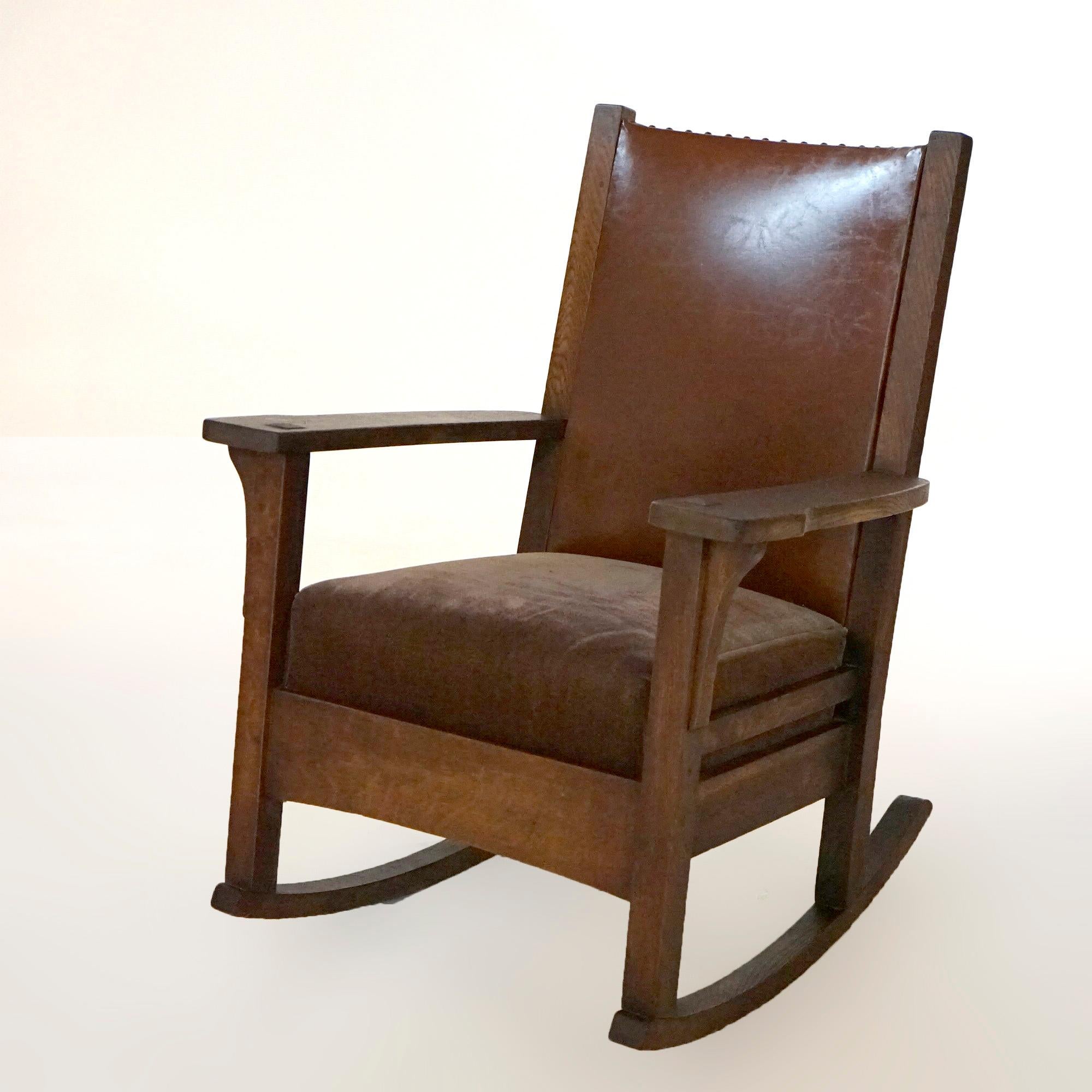 An antique Arts and Crafts Mission rocking chair by JM Young offers quarter sawn oak construction with upholstered back and seat, each arm having concave corbels, c1910.

Measures- 36.5''H x 28''W x 31.75''D; 18.5'' seat height.

*Ask about