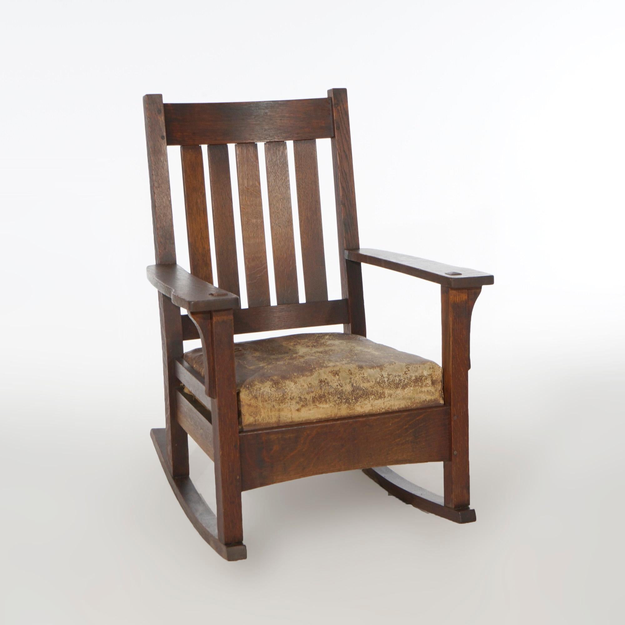 An antique Arts and Crafts Mission rocker by JM Young offers quarter sawn oak construction with slat back, c1910.

Measures- 36.75''H x 27.5''W x 30''D.

Catalogue Note: Ask about DISCOUNTED DELIVERY RATES available to most regions within 1,500