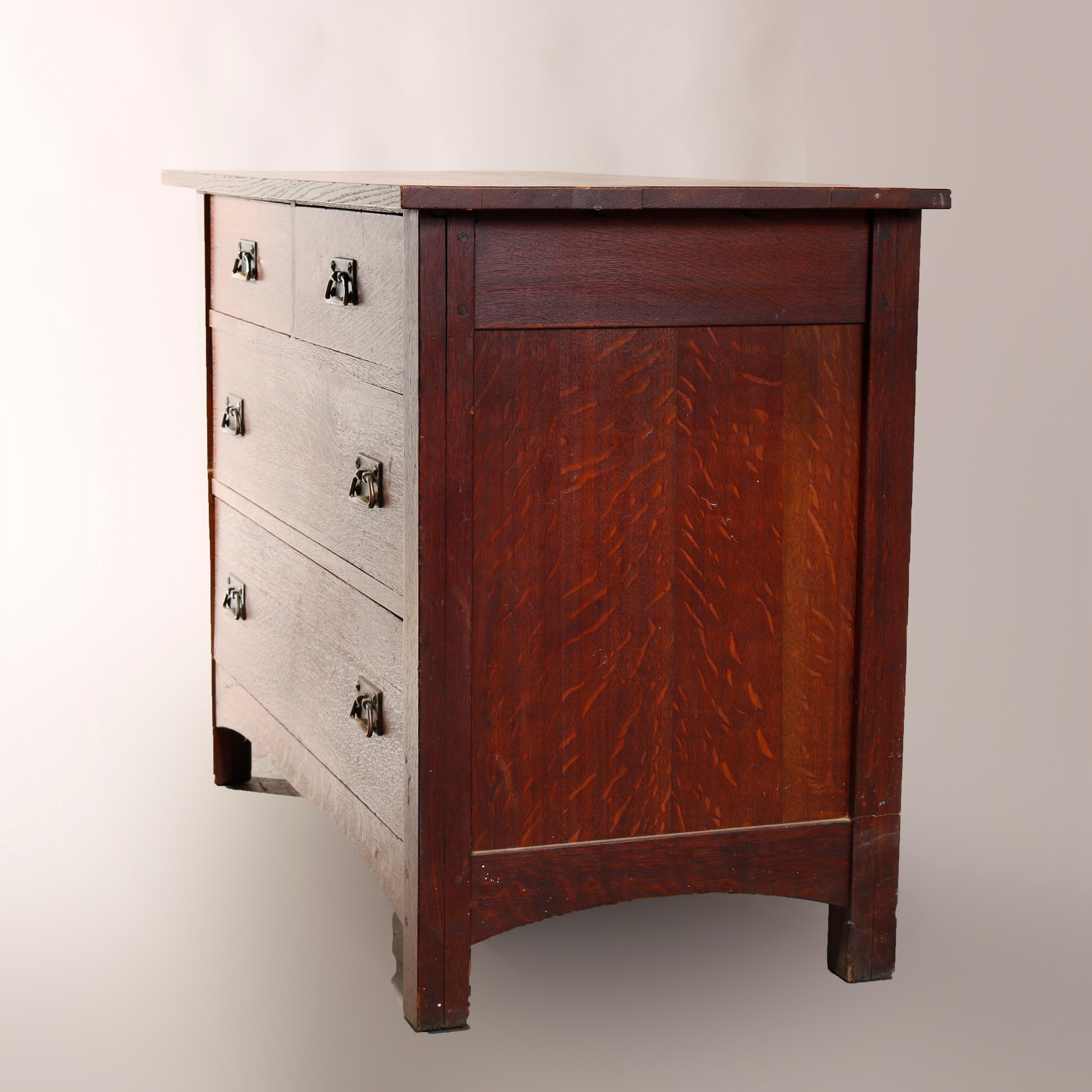 An antique Arts & Crafts mission chest of drawers attributed to Stickley offers oak construction with two small drawers over two long drawers, raised on straight and square legs having arched apron, circa 1910.

Measures: 33