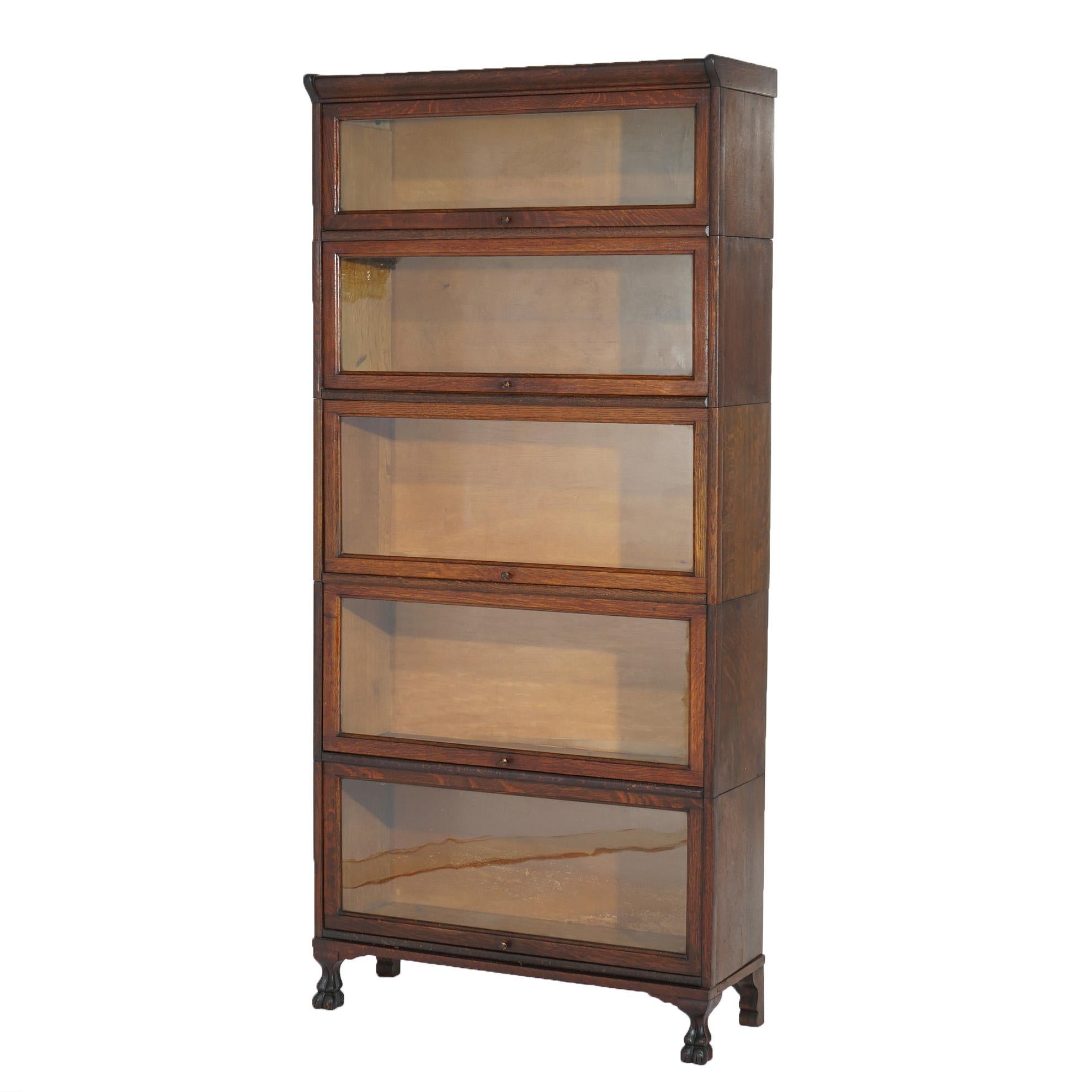 ***Ask About Discounted In-House Shipping***
An antique Arts & Crafts Mission barrister bookcase offers oak construction with five stacks, each having pullout glass doors, and raised on stylized paw feet, c1910

Measures - 73 1/4