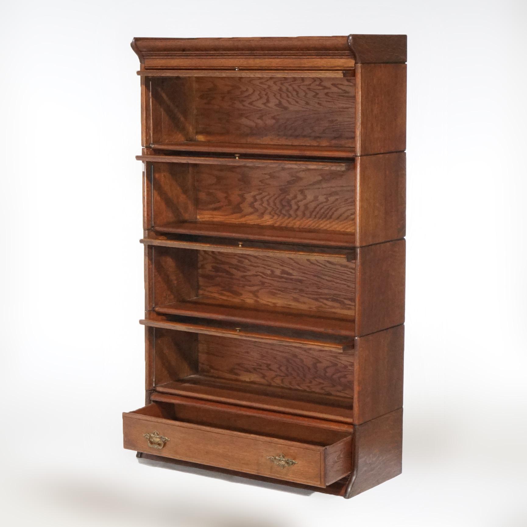 An antique Arts & Crafts mission barrister bookcase offers oak construction with four stacks, each having a pull-out glass door, over base with single long drawers, circa 1910.

Measures - 57.75