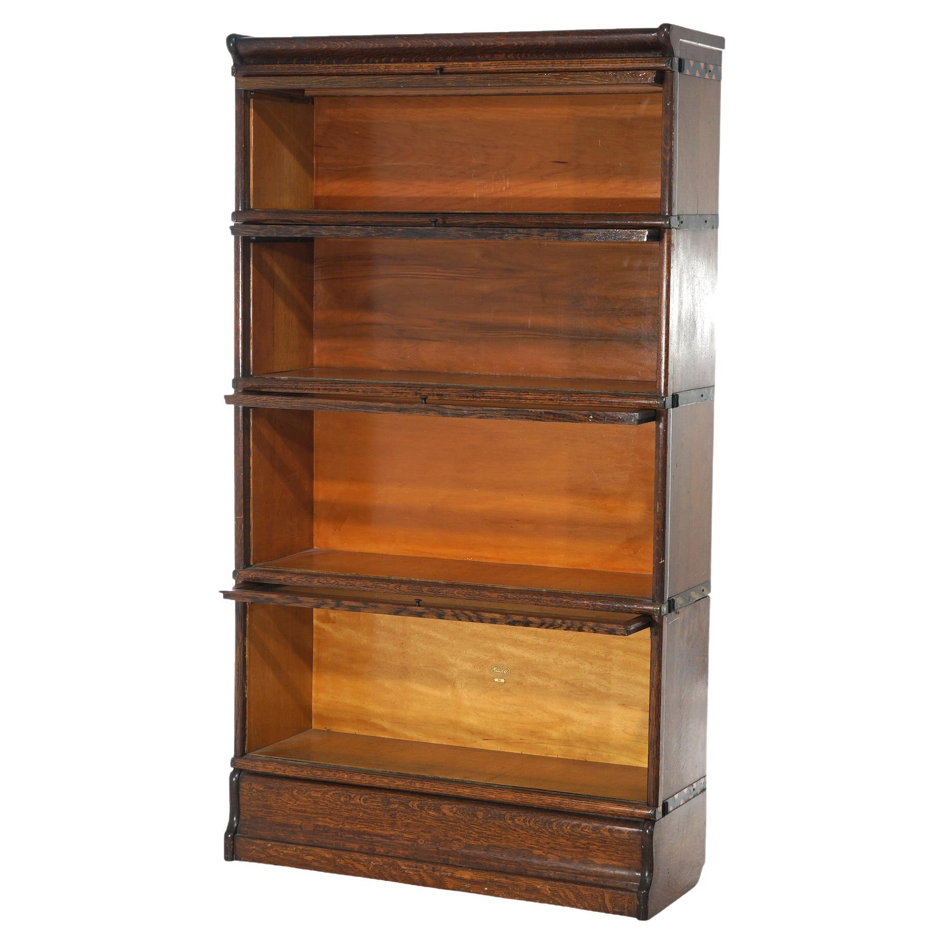 An antique Arts and Crafts Macey Mission barrister bookcase offers quarter sawn oak construction with four stacks, each having pullout glass doors, raised on ogee base, c1910

Measures - Overall 61.5''H x 34''W x 12.5''D; Shelf 1: 8.25''H x 31.5''W