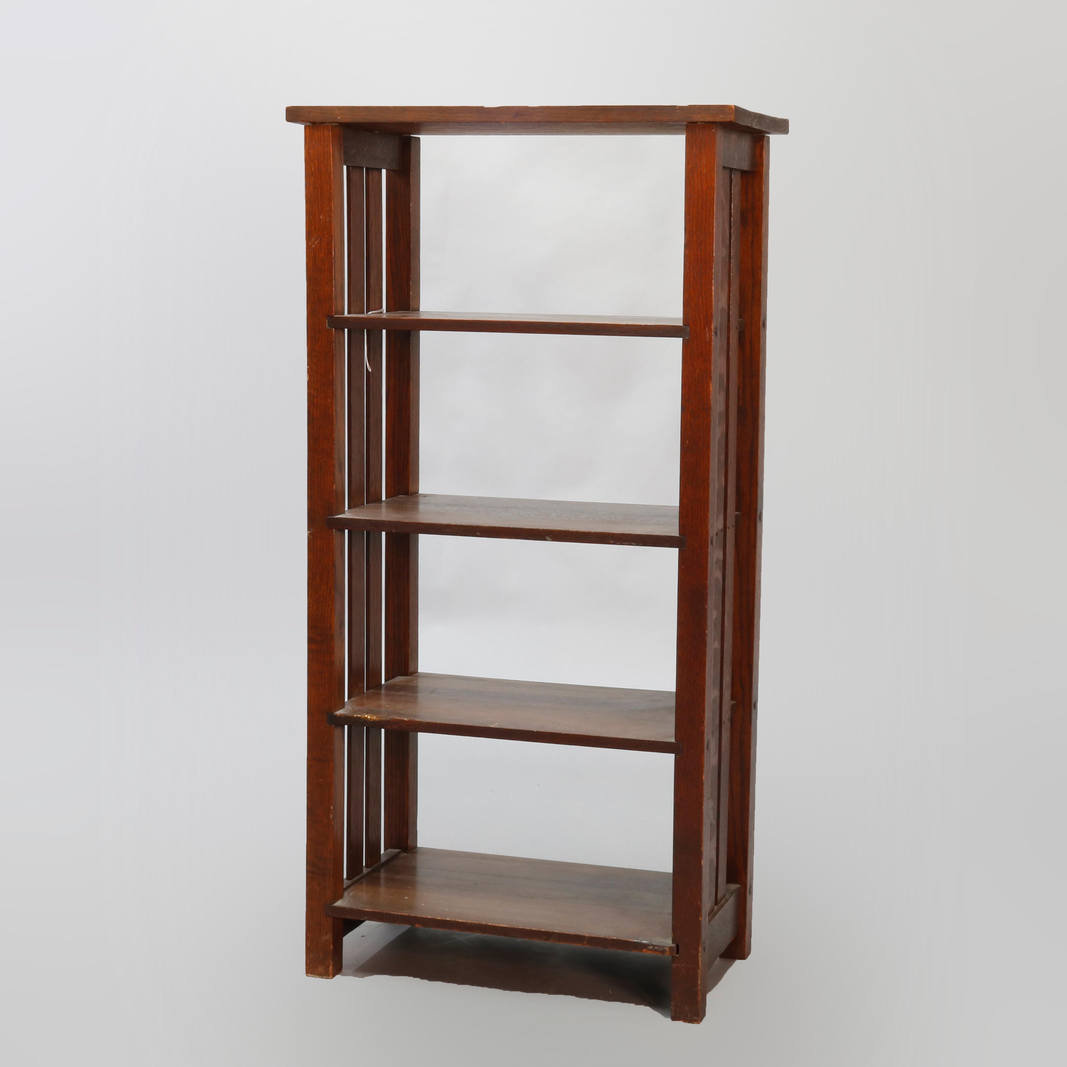 An antique Arts & Crafts mission oak magazine stand by Lakeside Crafters offers slat sides and four shelves, labeled on bottom as photographed, circa 1910

Measures: 43.38