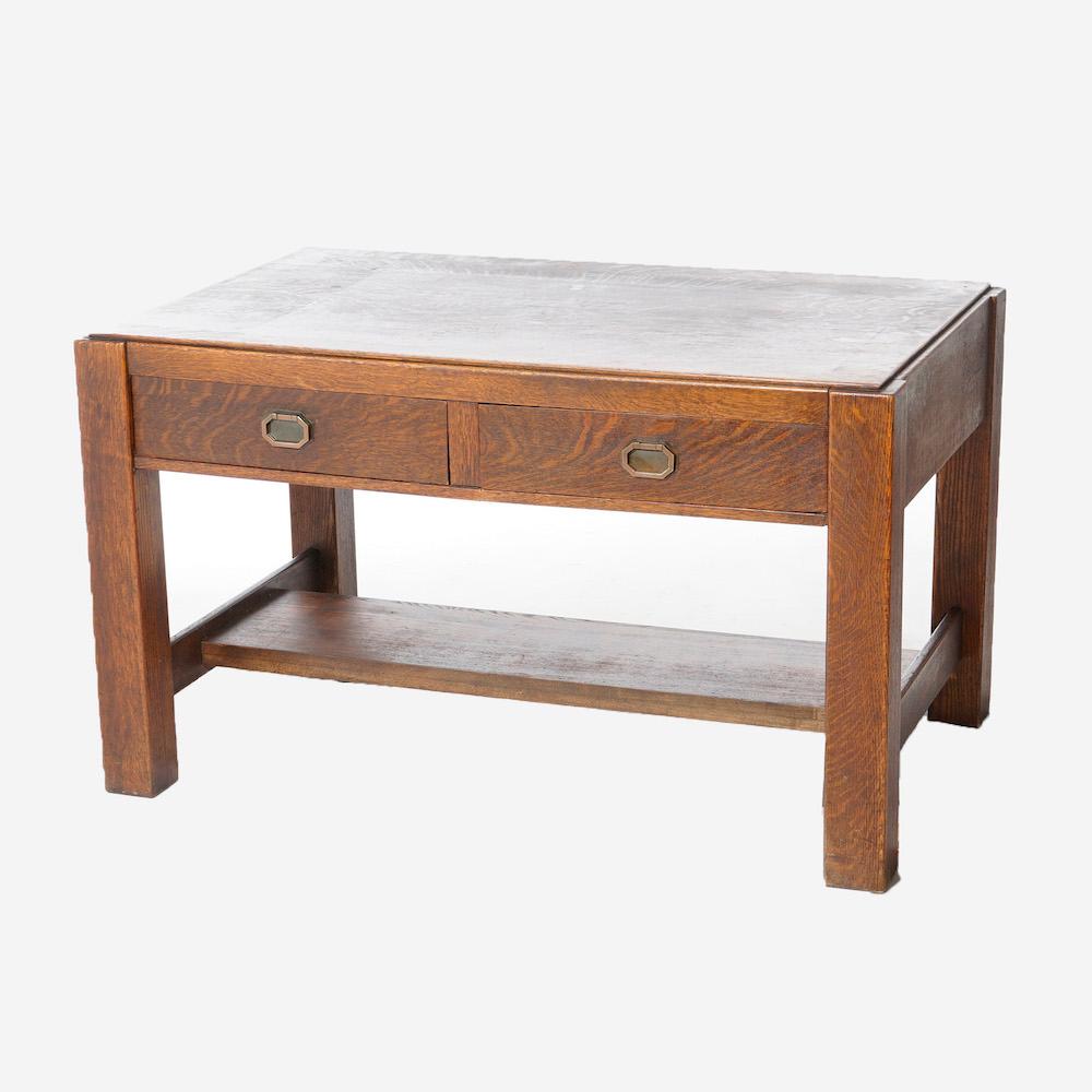 An antique Arts and Crafts Mission Grand Rapids library table offers quarter sawn oak construction with double drawers over base with lower shelf, c1910

Measures - 29.25