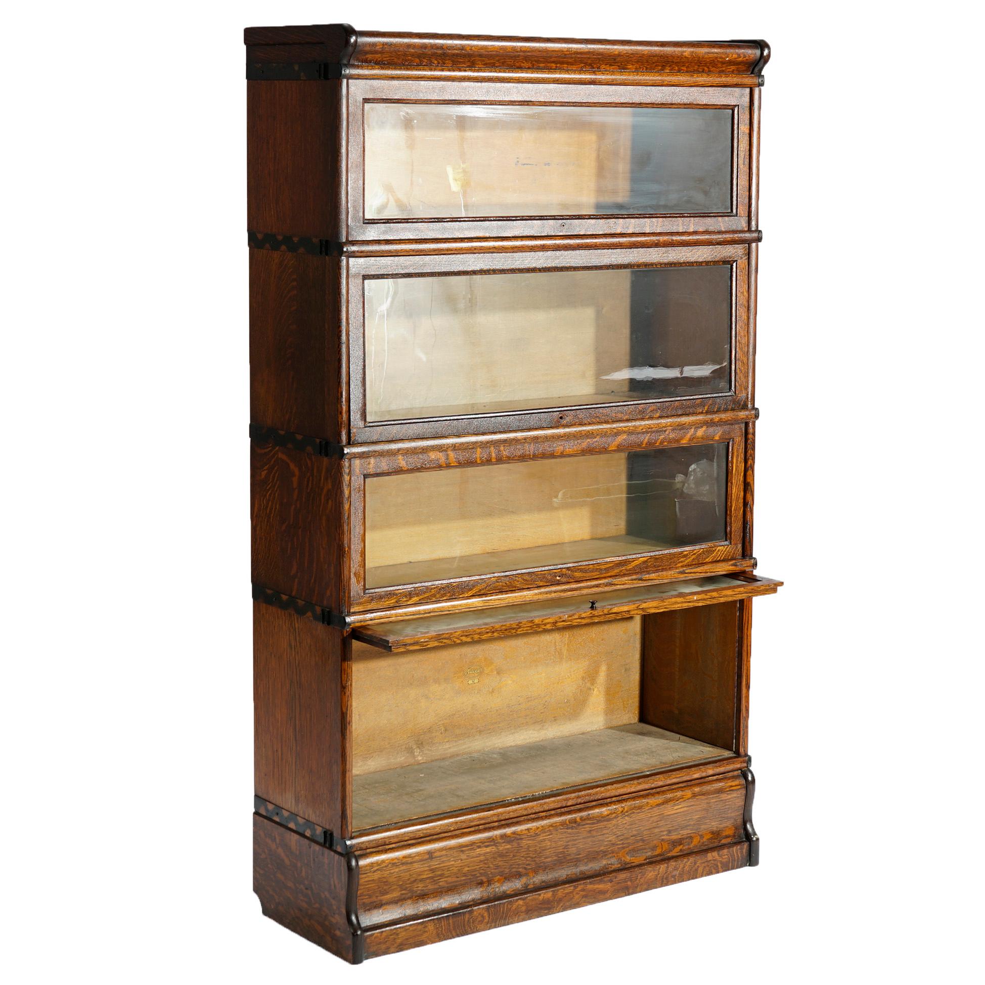 An antique Arts and Crafts Mission barrister bookcase attributed to Macey offers quarter sawn oak construction with four stacks, each having pull-out glass doors, seated on ogee base, circa 1910

Measures- 58.25'' H x 34.25'' W x 12.25''