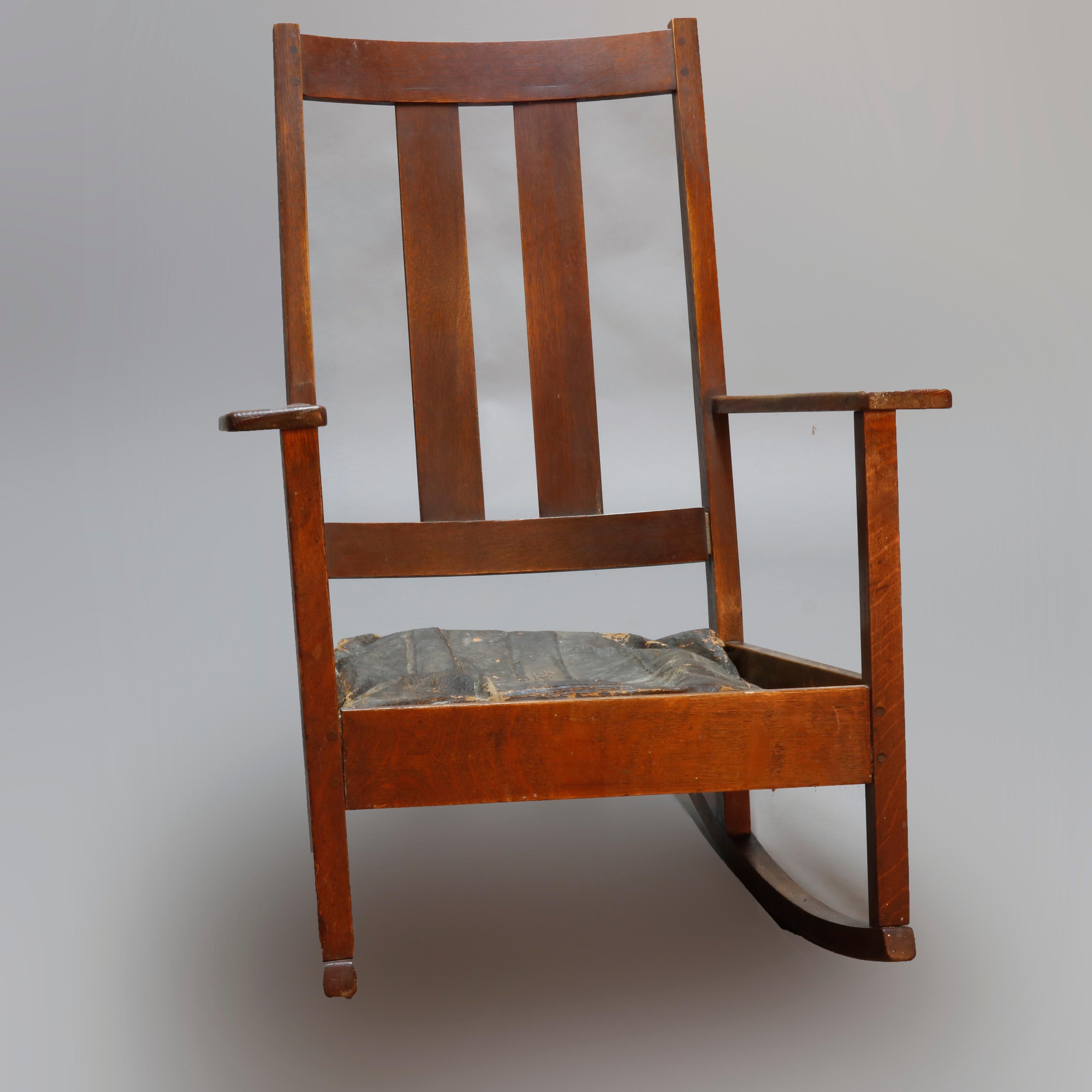 An antique Arts & Crafts Mission oak rocking chair by Limbert offers slat back and original maker label, circa 1910.

Measures: 40
