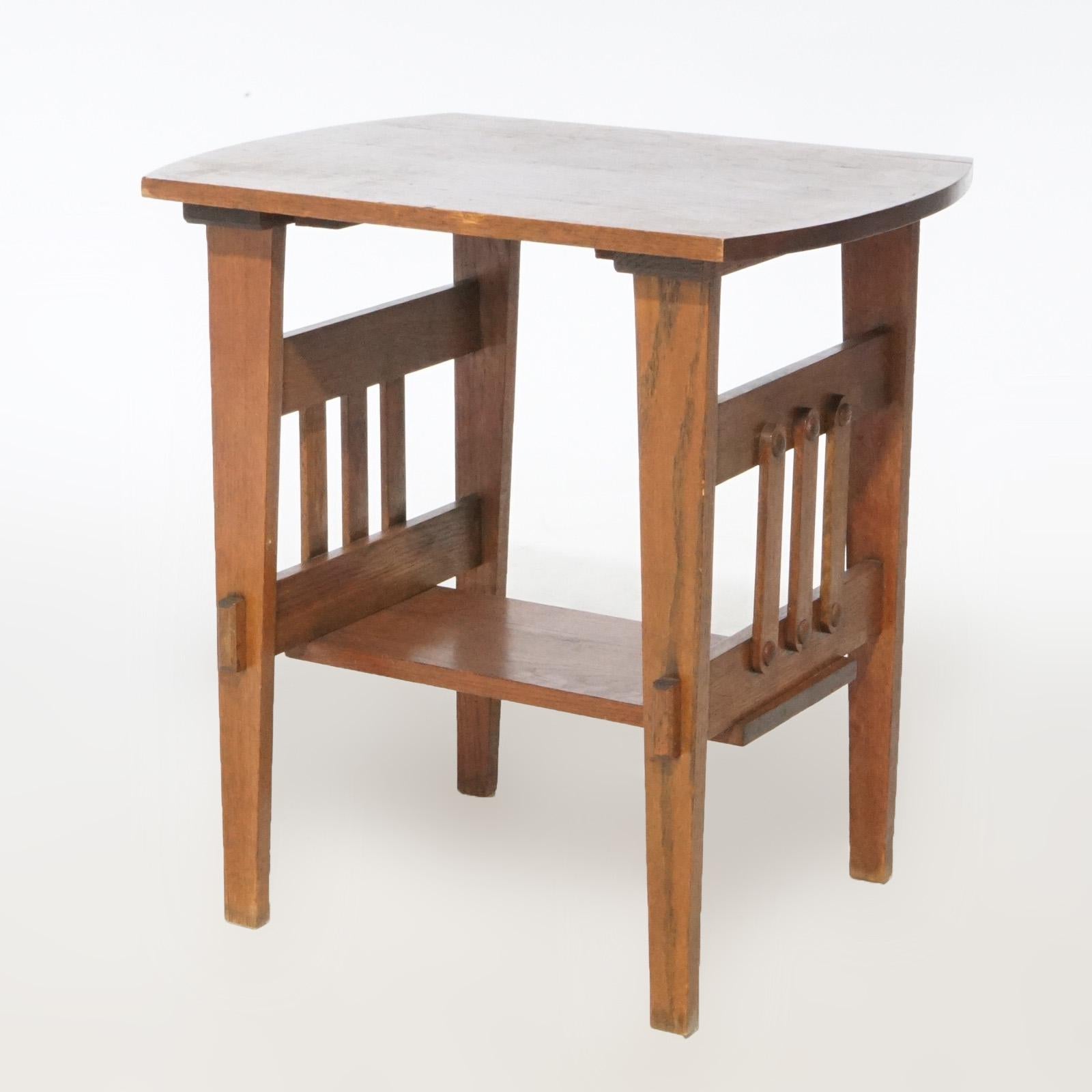 An antique Arts and Crafts Mission side table offers oak construction with spindle sides, circa 1910

Measures - 41.5