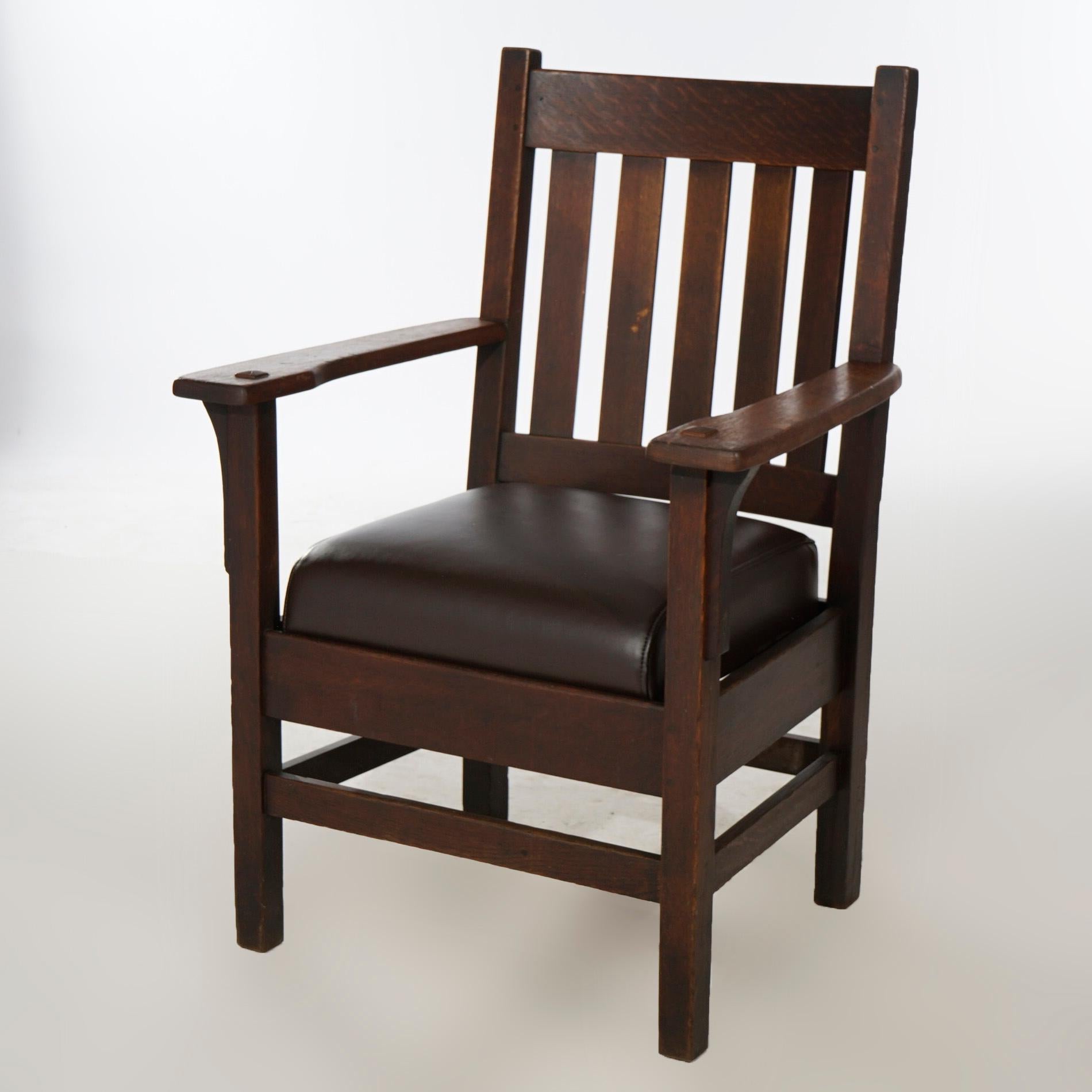 An antique Arts and Crafts Mission arm chair offers quarter sawn oak construction with slat back and upholstered seat, c1910.

Measures- 39.25''H x 27.5''W x 25''D.

*Ask about DISCOUNTED DELIVERY rates within 1,500 miles of NY*