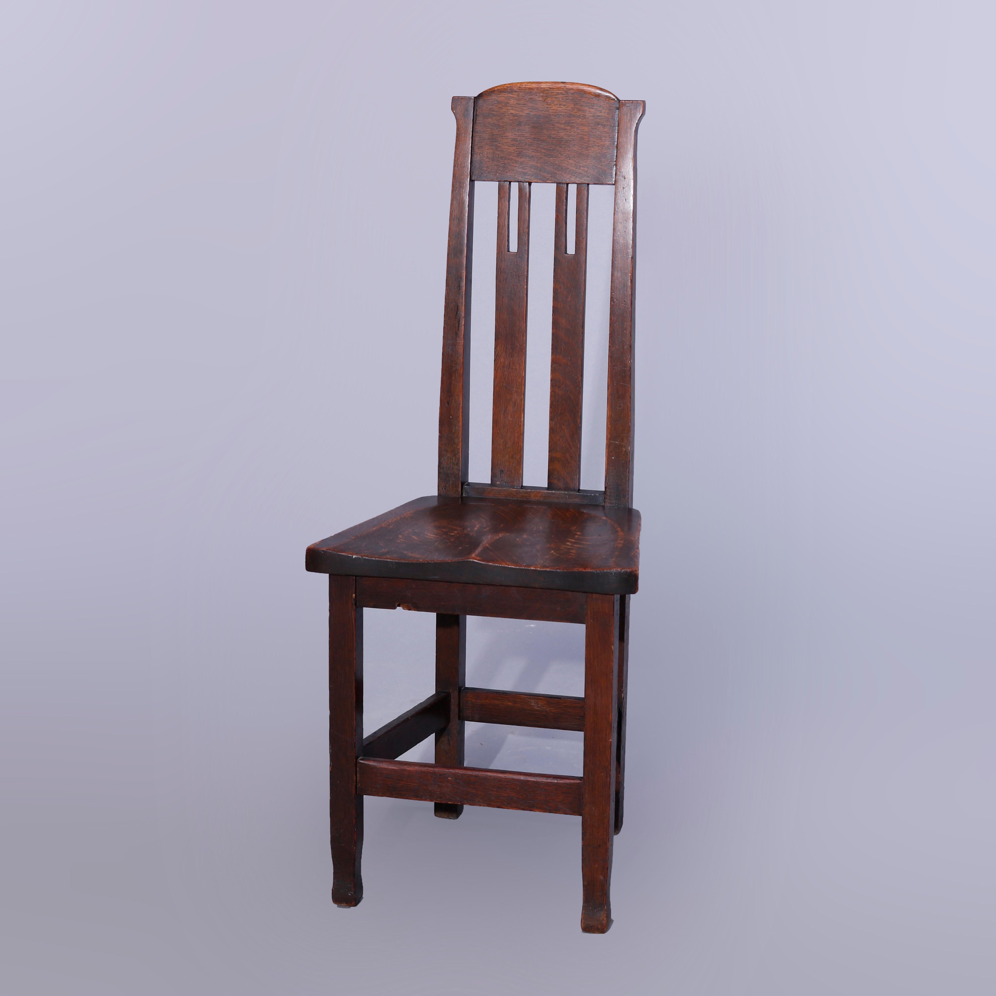 An antique Arts & Crafts Mission side chair in the manner of Stickley Bros. offers quarter sawn oak construction with tall slat back having cut-outs and over shaped seat, raised on straight legs terminating in McMurdo feet, c1910
 
Measures -