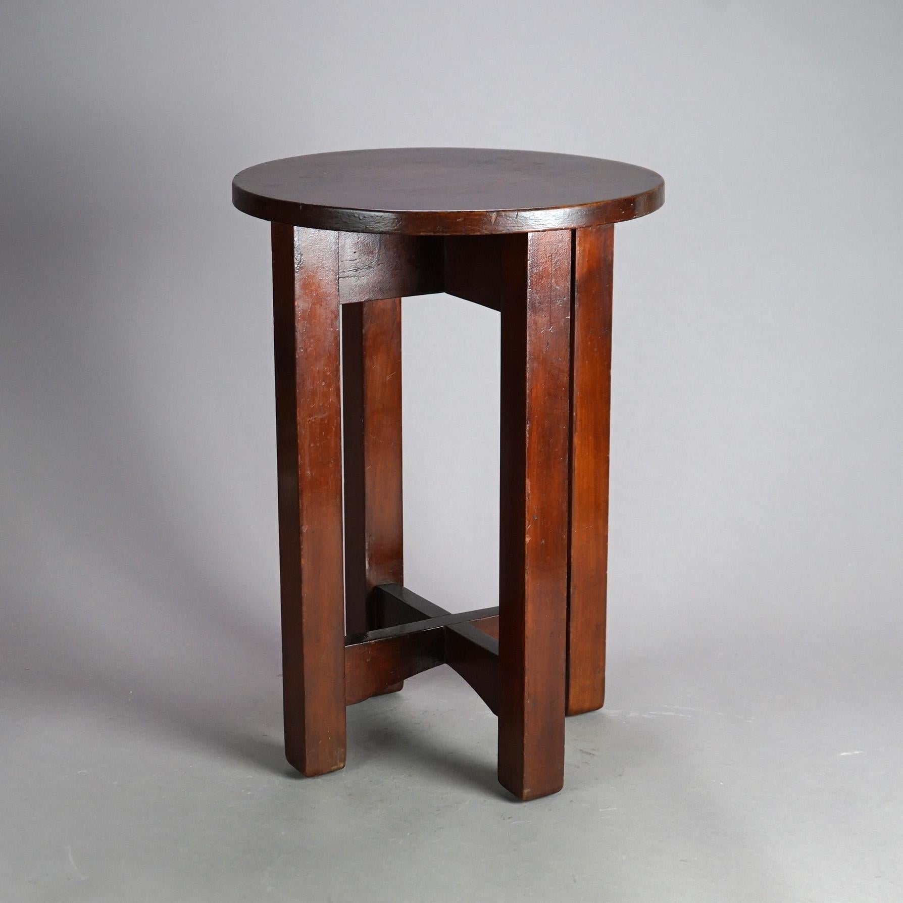 An antique Arts and Crafts Mission tabouret stand in the manner of Stickley offers oak construction with round top raised on straight square legs having x-stretcher, c1910

Measures - 20