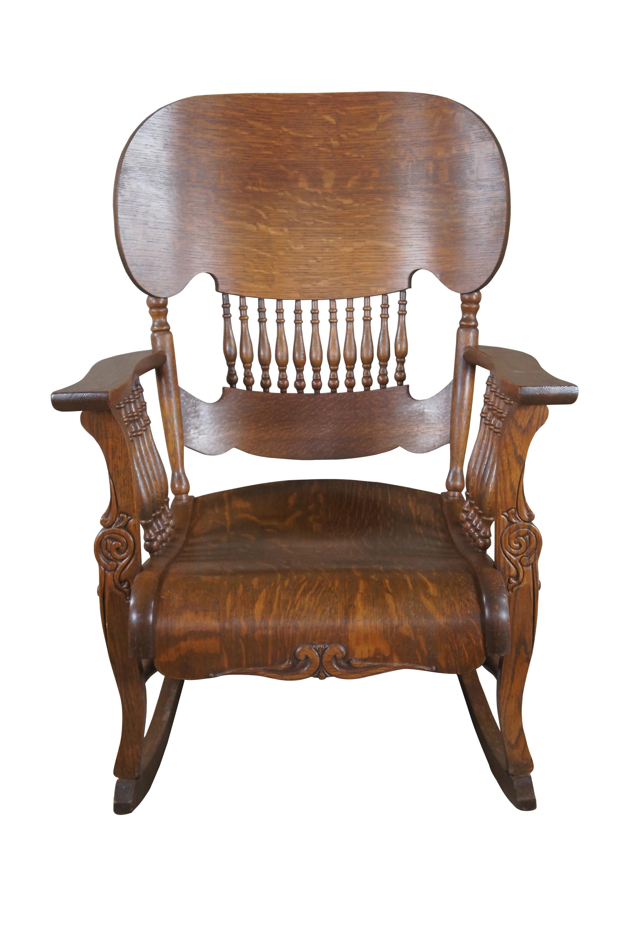 A gorgeous American Arts and Crafts Mission chair, circa 1930s This gem features a spindle side and back leading to a shielded crown and serpentine apron. Made from Quartersawn (Tiger Oak) with a bentwood seat. Carved accents ordain the front sides