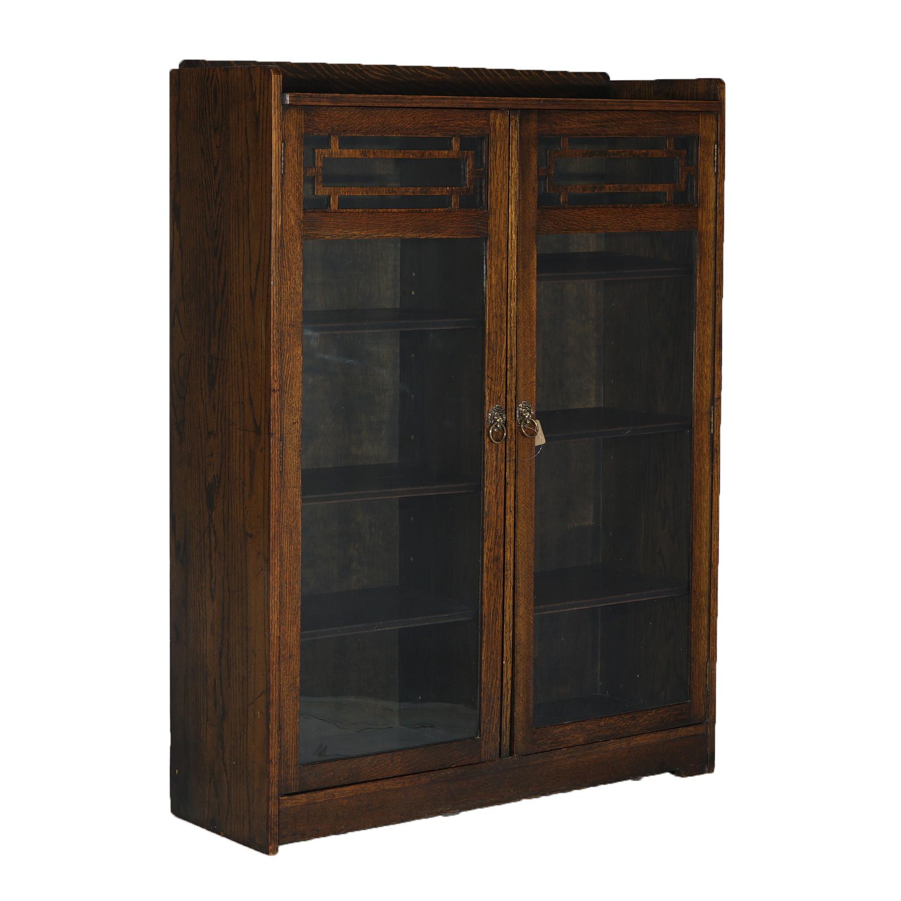 ***Ask About Lower In-House Shipping Rates - Reliable Service, Competitive Rates & Fully Insured***
An antique Arts and Crafts Mission bookcase in the manner of Stickley offers oak construction with upper gallery over case with double doors opening