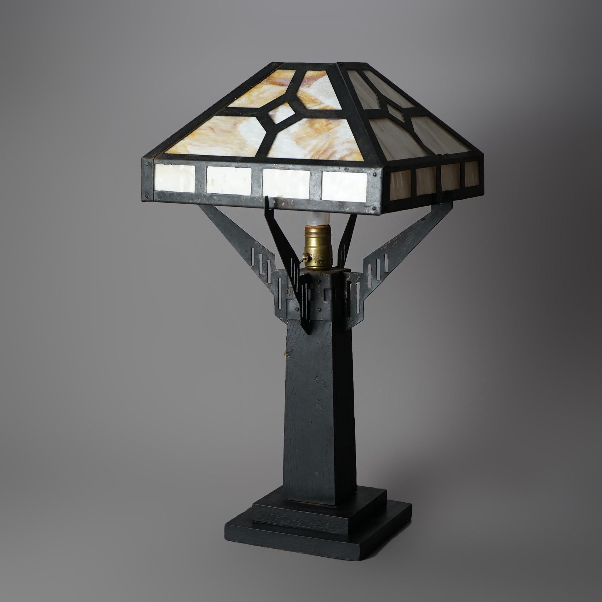 An antique Arts and Crafts Mission style table lamp offers slag glass shade over single socket base, c1920

Measures - 23