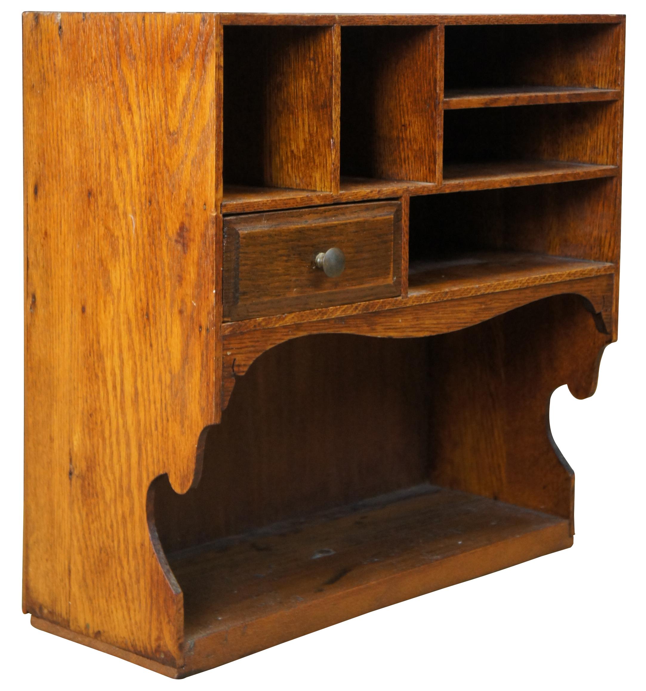Antique oak desktop or hanging organizer. Includes 5 cubbies and a drawer for storage over a large lower shelf.
