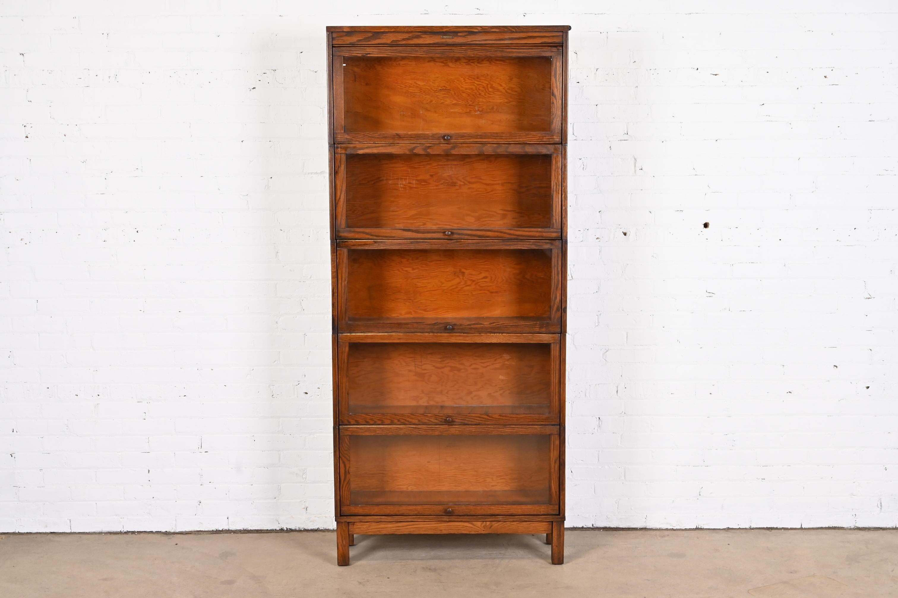 A gorgeous antique Mission oak Arts & Crafts five-stack barrister bookcase

By Lundstrom

USA, Circa 1920s

Oak, with glass front doors and brass hardware.

Measures: 33.75
