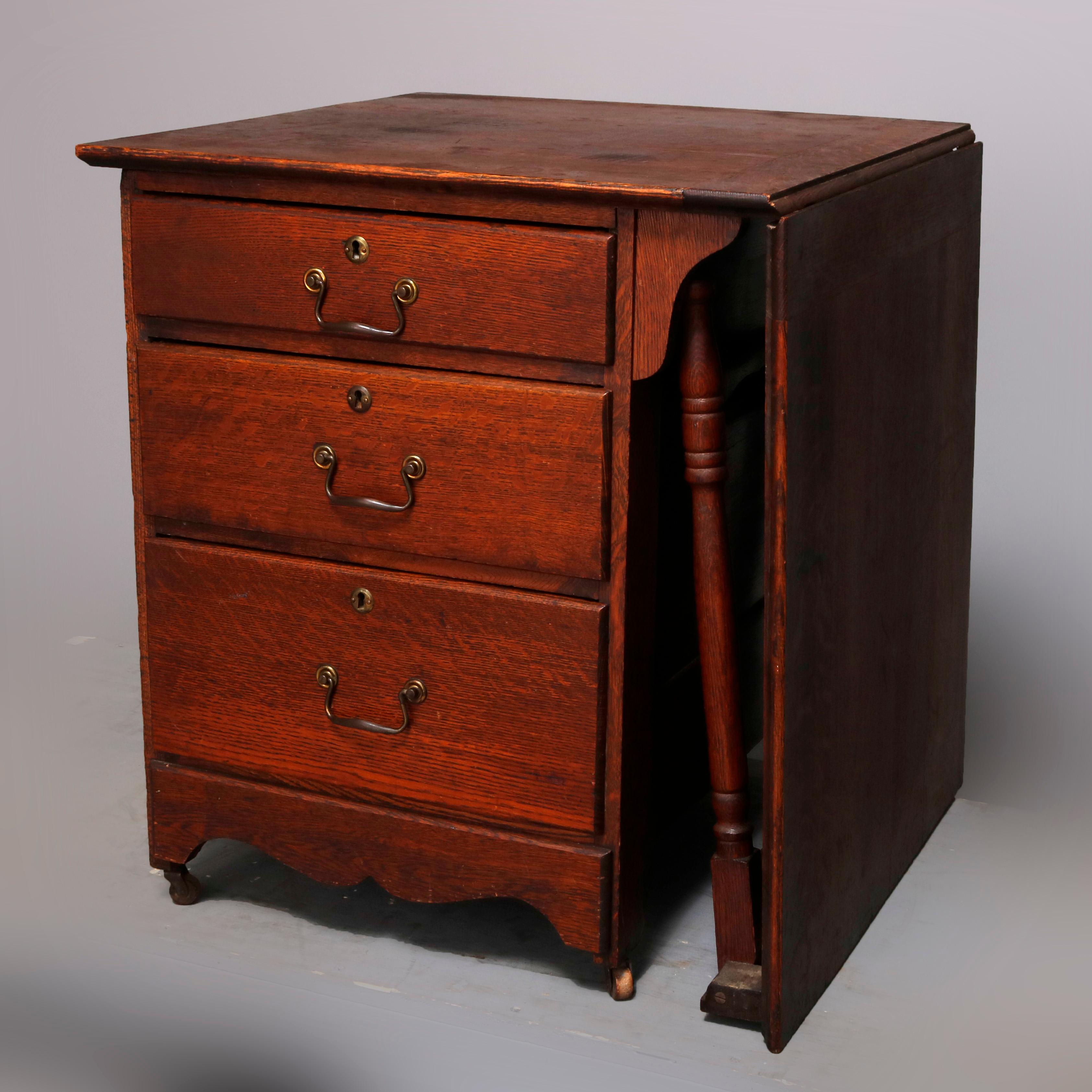 An antique Arts & Crafts work or sewing table by Larkin offers oak construction with case having three drawers, paneled sides and shaped skirt surmounted by fold up work surface providing desk with Sheraton legs, circa 1910

***DELIVERY NOTICE – Due