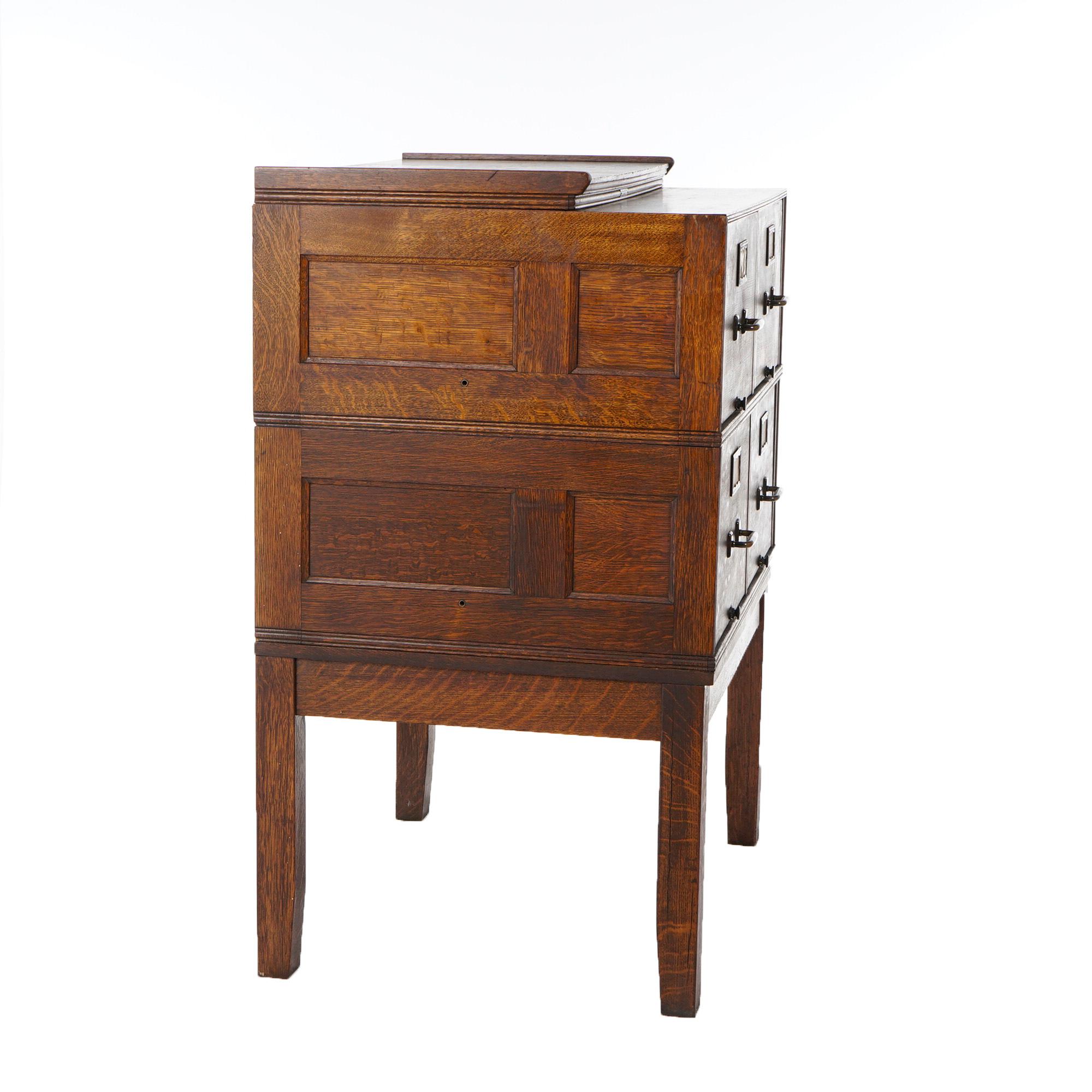 An antique Arts and Crafts stack filing cabinet offers quarter sawn oak construction in panel form with four drawers, c1910

Measures- 45''H x 33''W x 26.25''D.