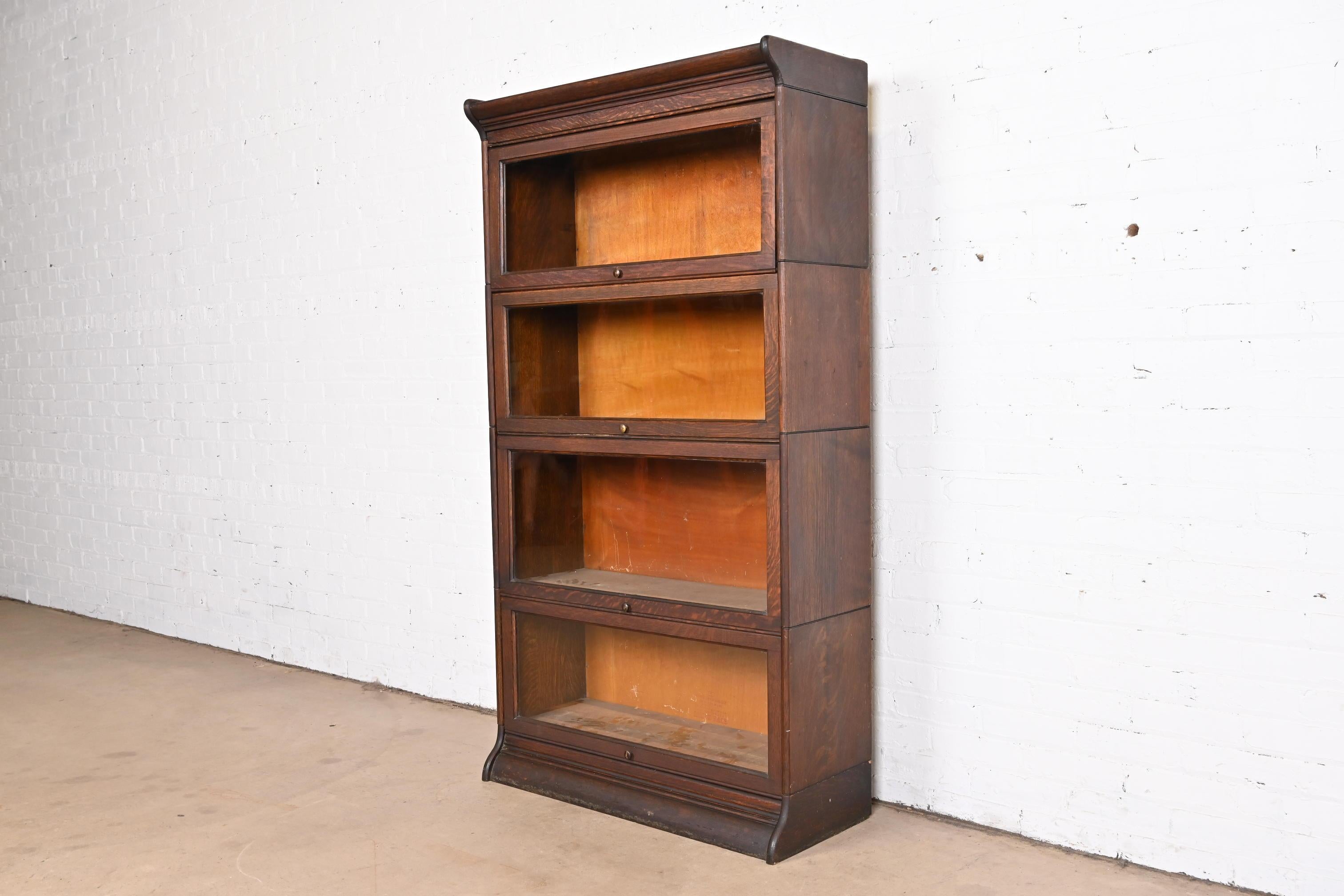 A gorgeous antique Arts and Crafts four-stack barrister bookcase

By Gunn

USA, circa 1920s

Quarter sawn oak, with glass front doors and brass hardware.

Measures: 34.13